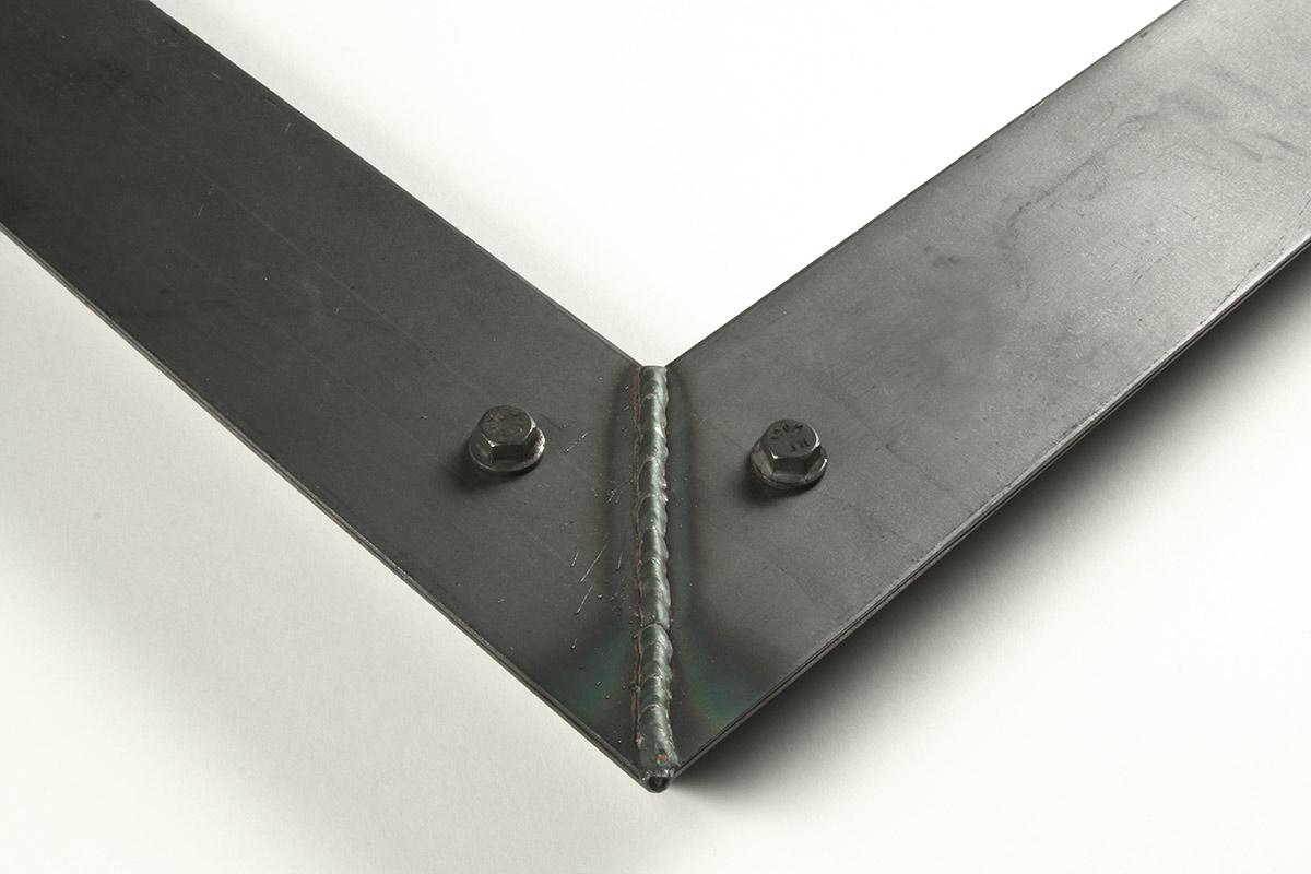 Detail of a 2.5” wide molding steel frame with bolt decoration