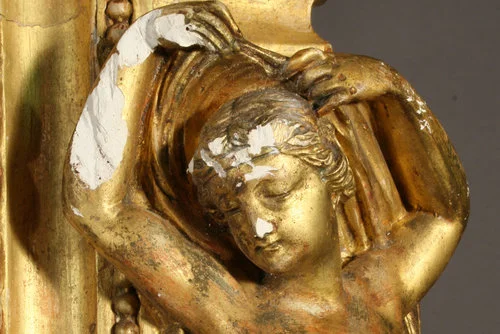Sculpted figure before treatment. Note deep gesso damage. The missing material had to be sculpted in order restore the shape of the arm face details.
