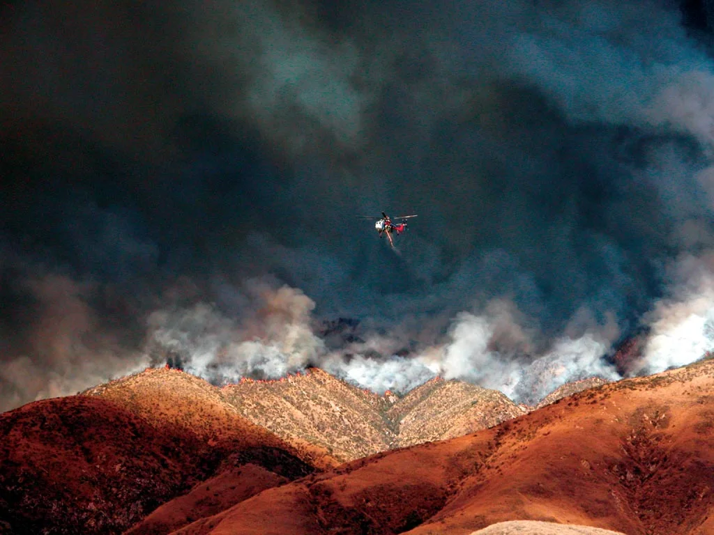 Helicopter returns for another load after dropping water on the front lines of the Old Fire in the foothills of the San Bernardino Mountains. (photo courtesy of Matt Artz)