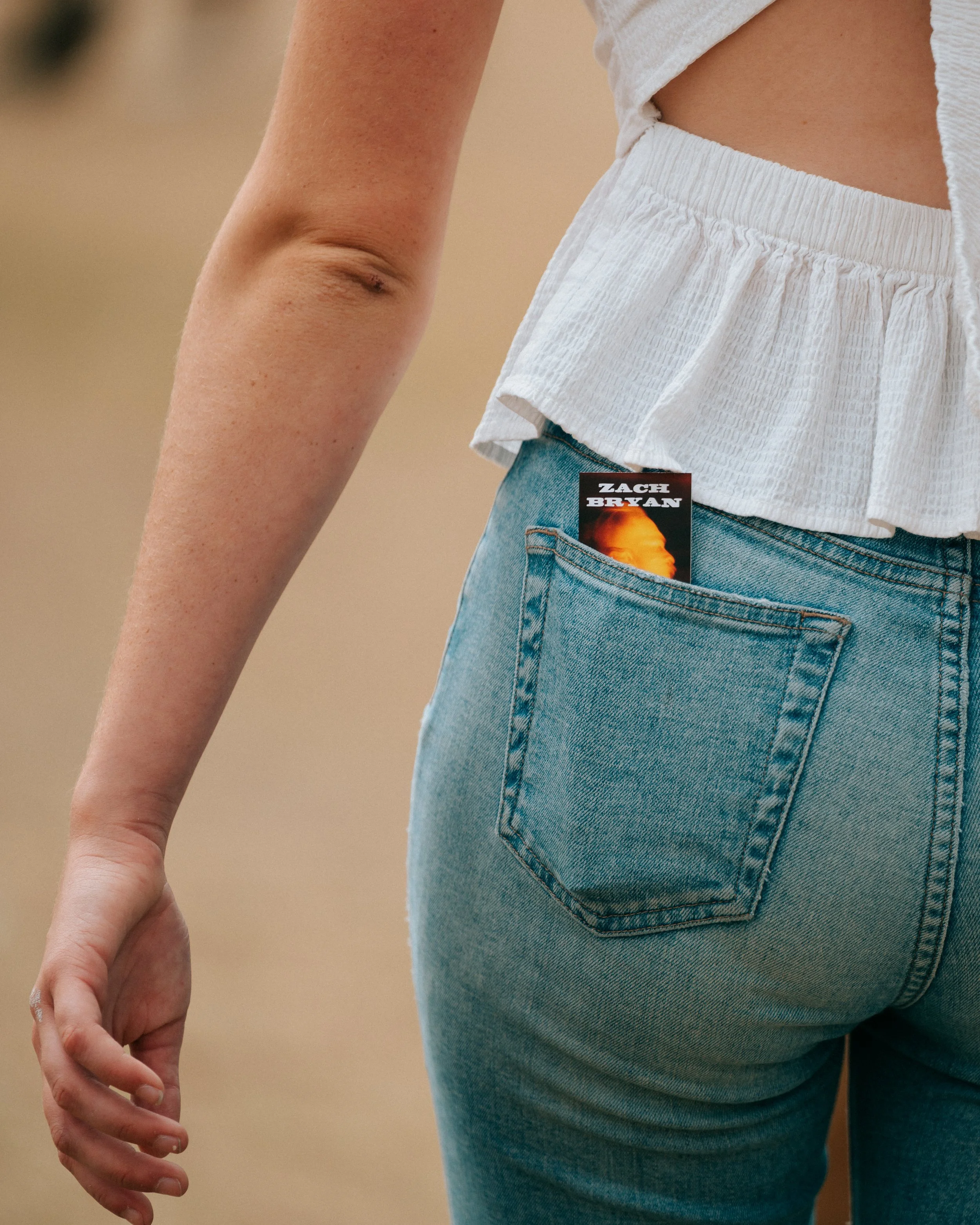 Zach Bryan ticket tucked in a denim back pocket