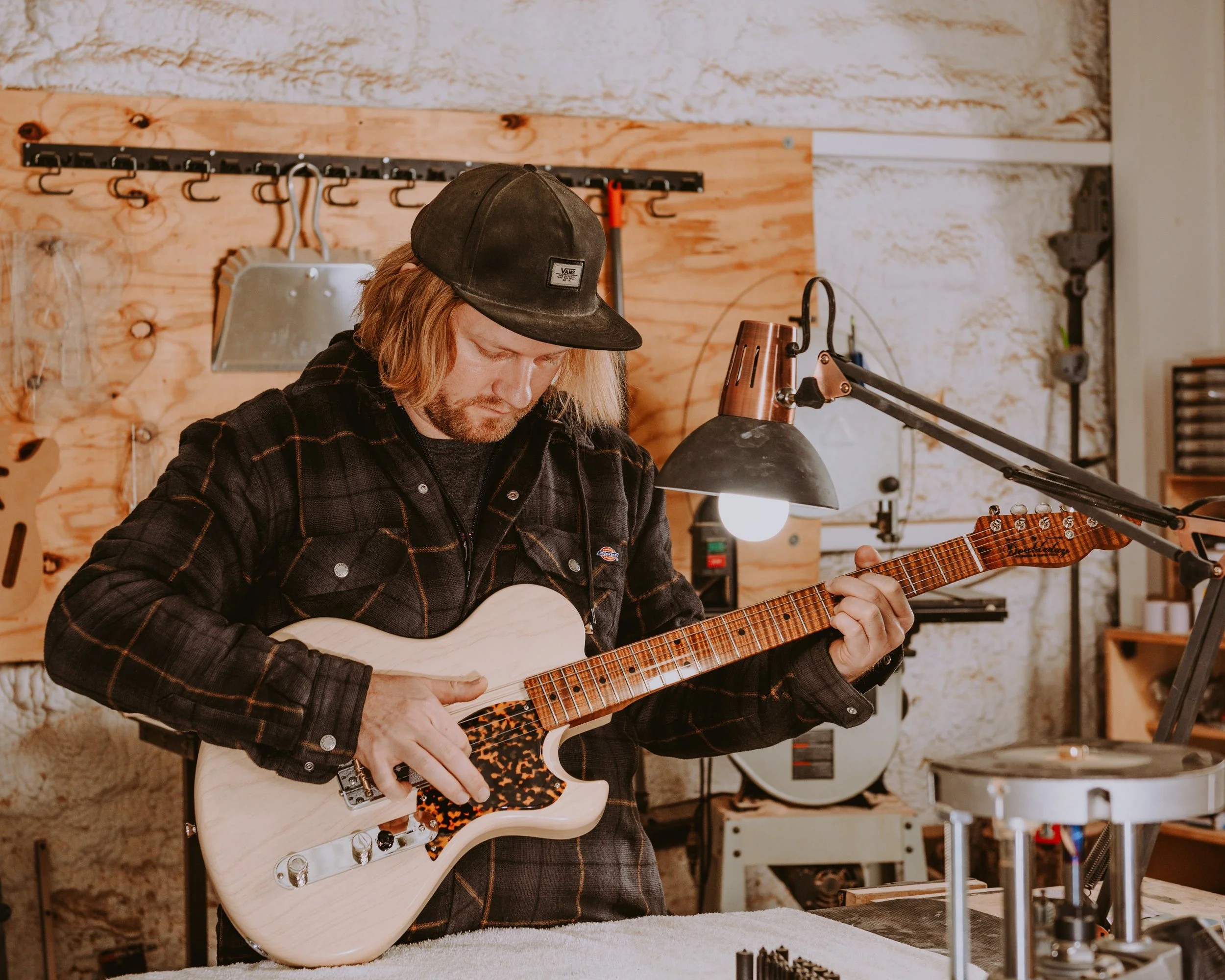 Walker Doubleday at the Shop tuning a guitar in Austin, Texas