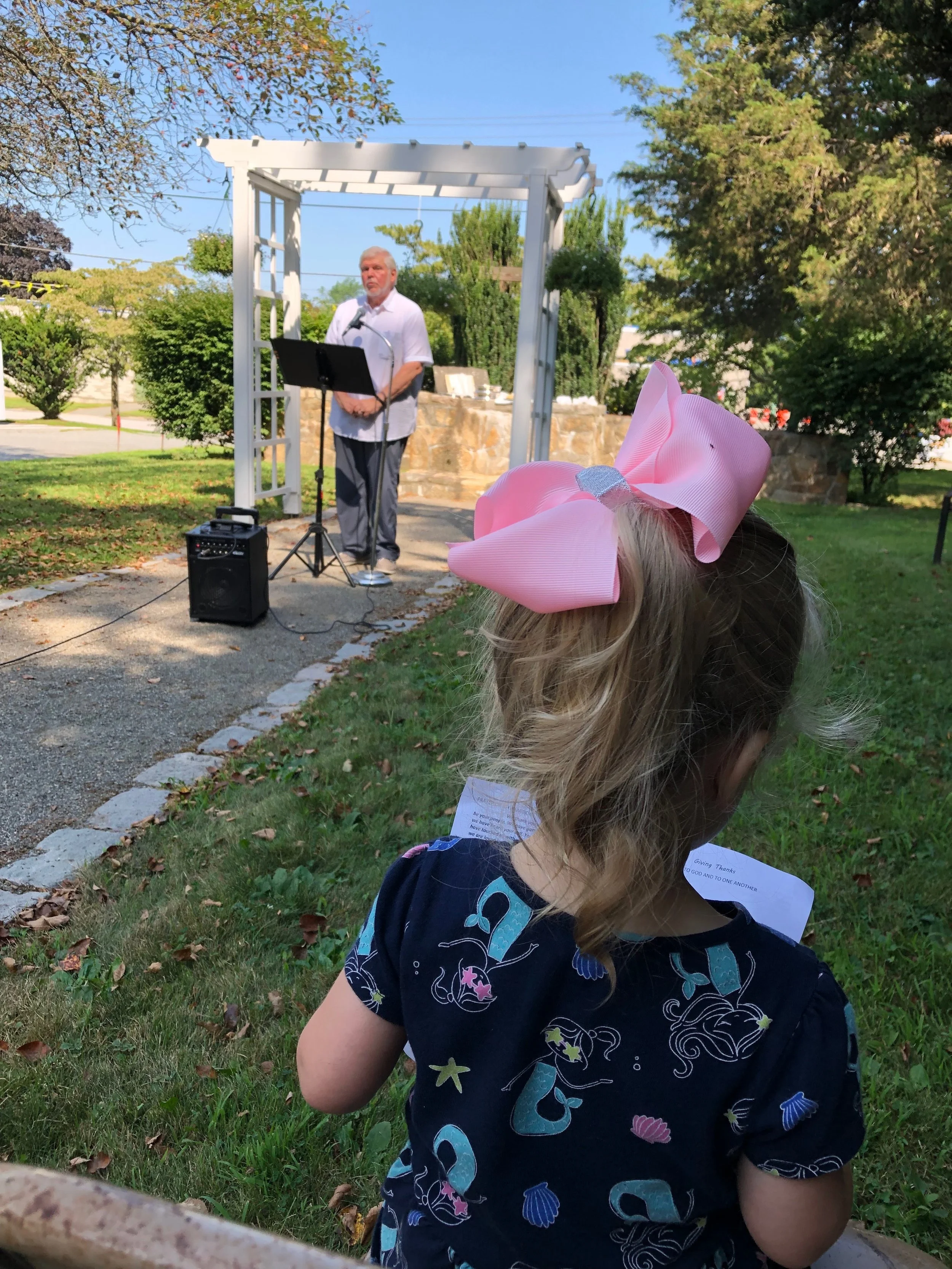 Callie Cranshaw enjoys the message given by Pastor Gene at the outdoor chapel on August 4th