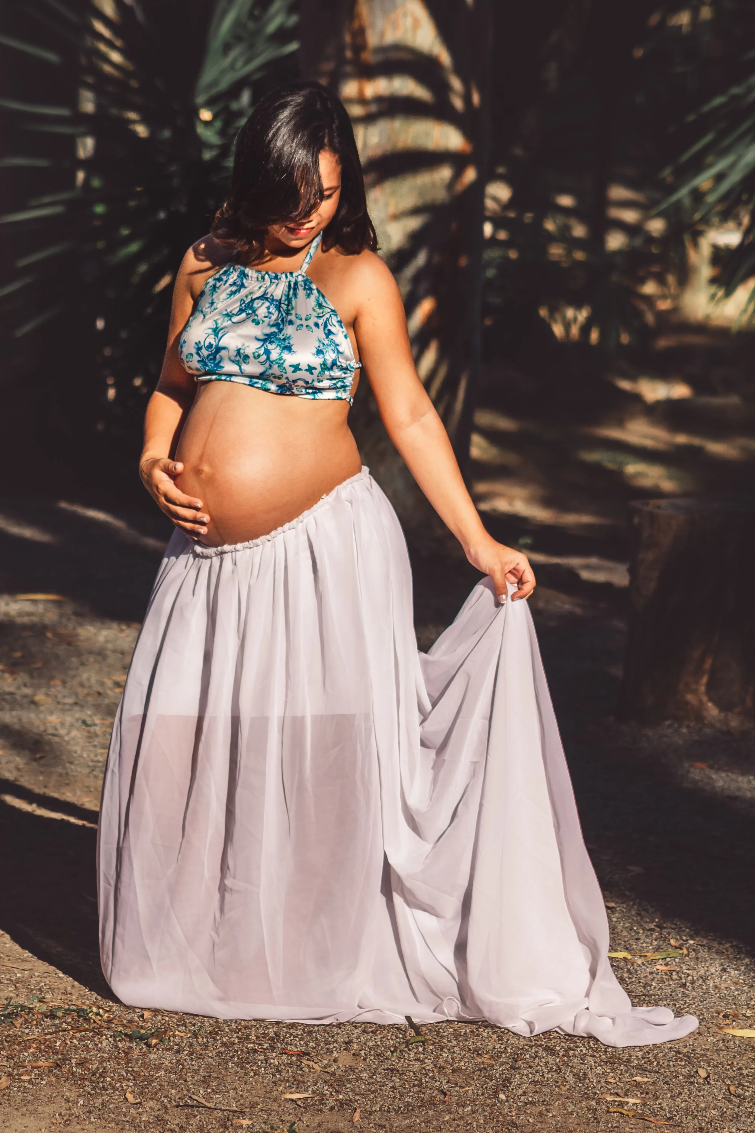 Image: a pregnant woman in a bra top and flowing skirt. Image credit: Pexels