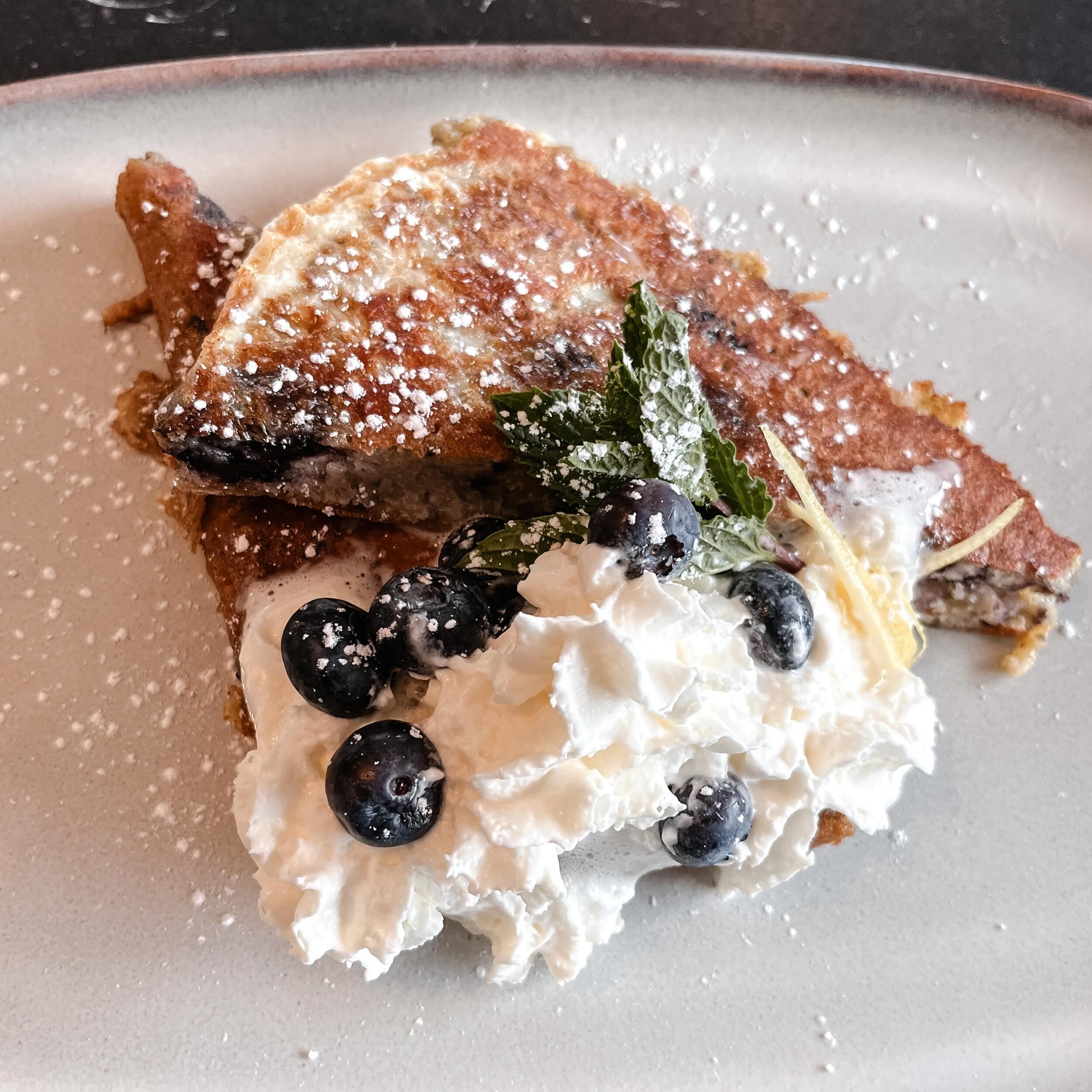 🫐Blueberry Bread French Toast 🫐| garnished with whipped cream, fresh mint and lemon zest. On special today!