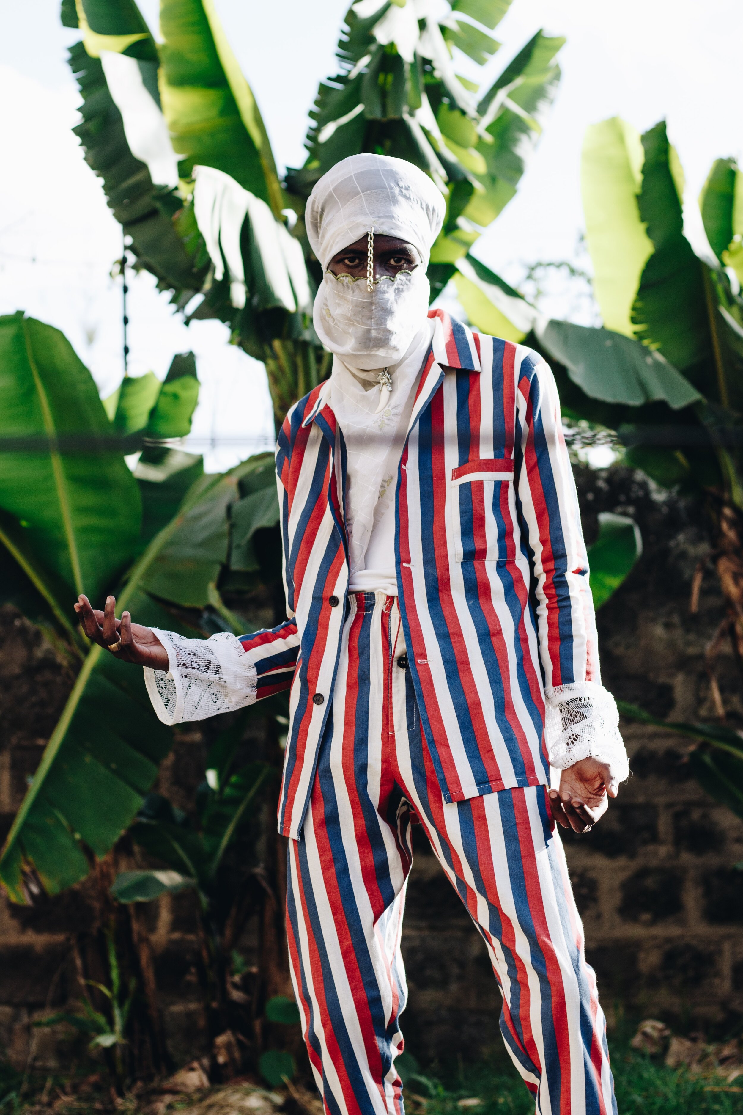 man-in-blue-white-and-red-striped-suit-standing-near-banana-2297592.jpg