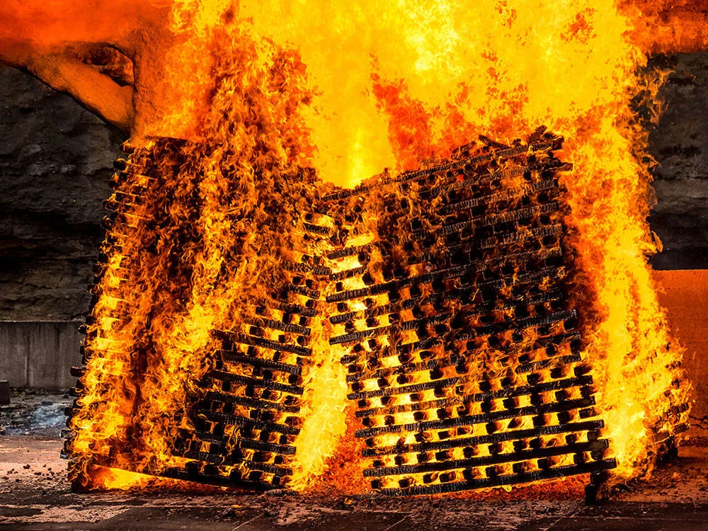Four ricks of Sugar Maple Charcoal being burned under the hood to ship over to the distillery.