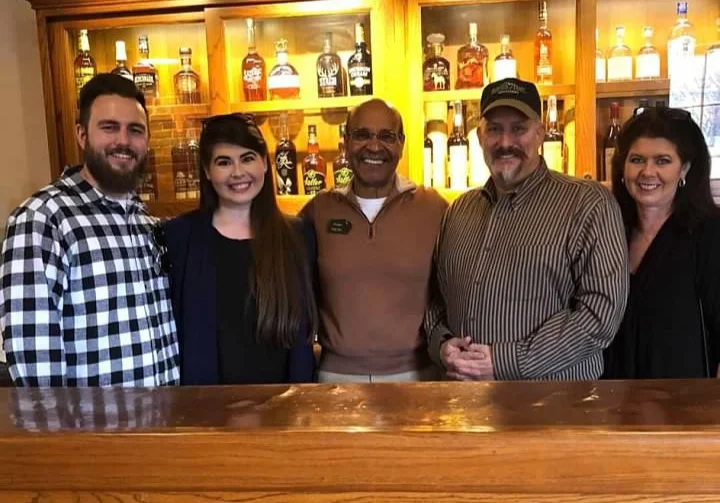 Some of the Administration of Whiskey University posing with Bourbon Hall of Famer Freddie Johnson at a tasting after a Tour at the Buffalo Trace Distillery . Pictured above are Professor Nicolas Goodall, Web Master Alexandra “Lexie” Duncan , Buffalo Trace’s Freddie Johnson, Founder of Whiskey University Professor Colonel Craig Duncan and Administrator Melissa Duncan.