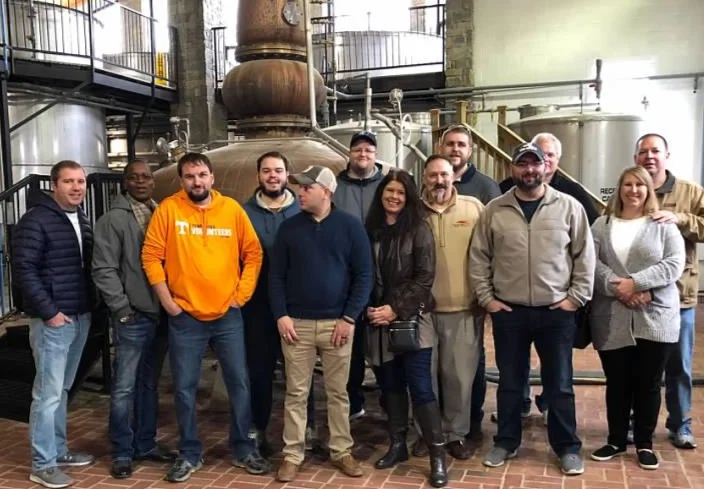 Some of the Staff of Whiskey University in from of the Pot Still at the Willett Distillery. Pictured above from left to right Professor Lt. Colonel Christopher Hart, Devere Walker, Professor Lt. Colonel Carl Ingrum, Bobby Graham, guest, Casey Williams, Administrator Melissa Duncan, Professor Colonel Craig Duncan, Dakota Mercer, Professor Lt. Colonel Christopher Yow, Professor Lt. Colonel Ross Osborne, Monya Hunter and John Hunter.