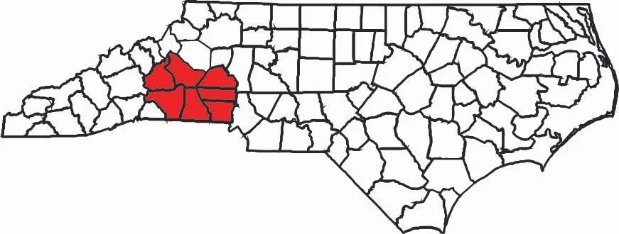 Map of North Carolina highlighting five counties in the western part of the state in red.