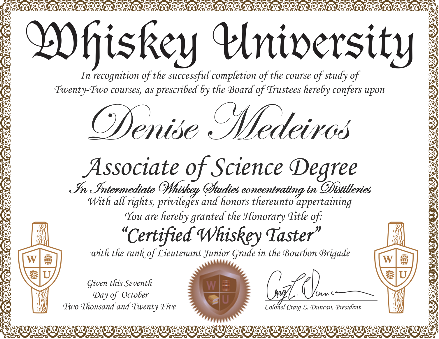 Certificate of achievement from Whiskey University awarded to Denise Medeiros, recognizing her as a Certified Whiskey Taster with a Lieutenant Junior Grade rank in the Bourbon Brigade, signed by Colonel Craig L. Duncan.