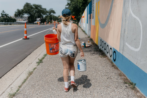 ellen rutt working on a mural.jpeg