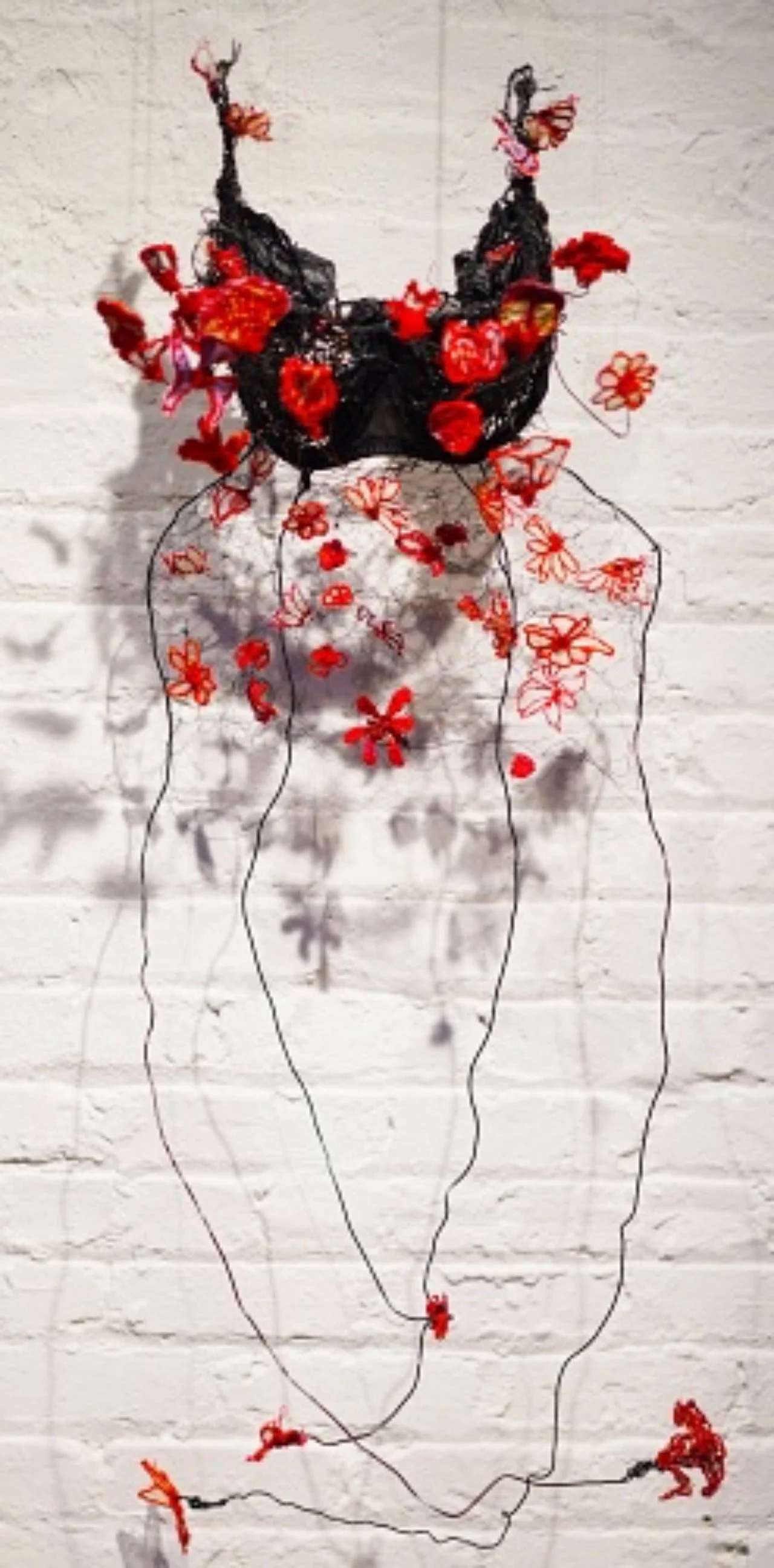 “ M ani c E pi sod e , C h i ca g o , 2 0 1 3-2 0 1 4” Bra hand embroidered into needle lace with hand embroidered flowers wrapped around wire, 14x45x12 Inches.  From Fleshmap series.