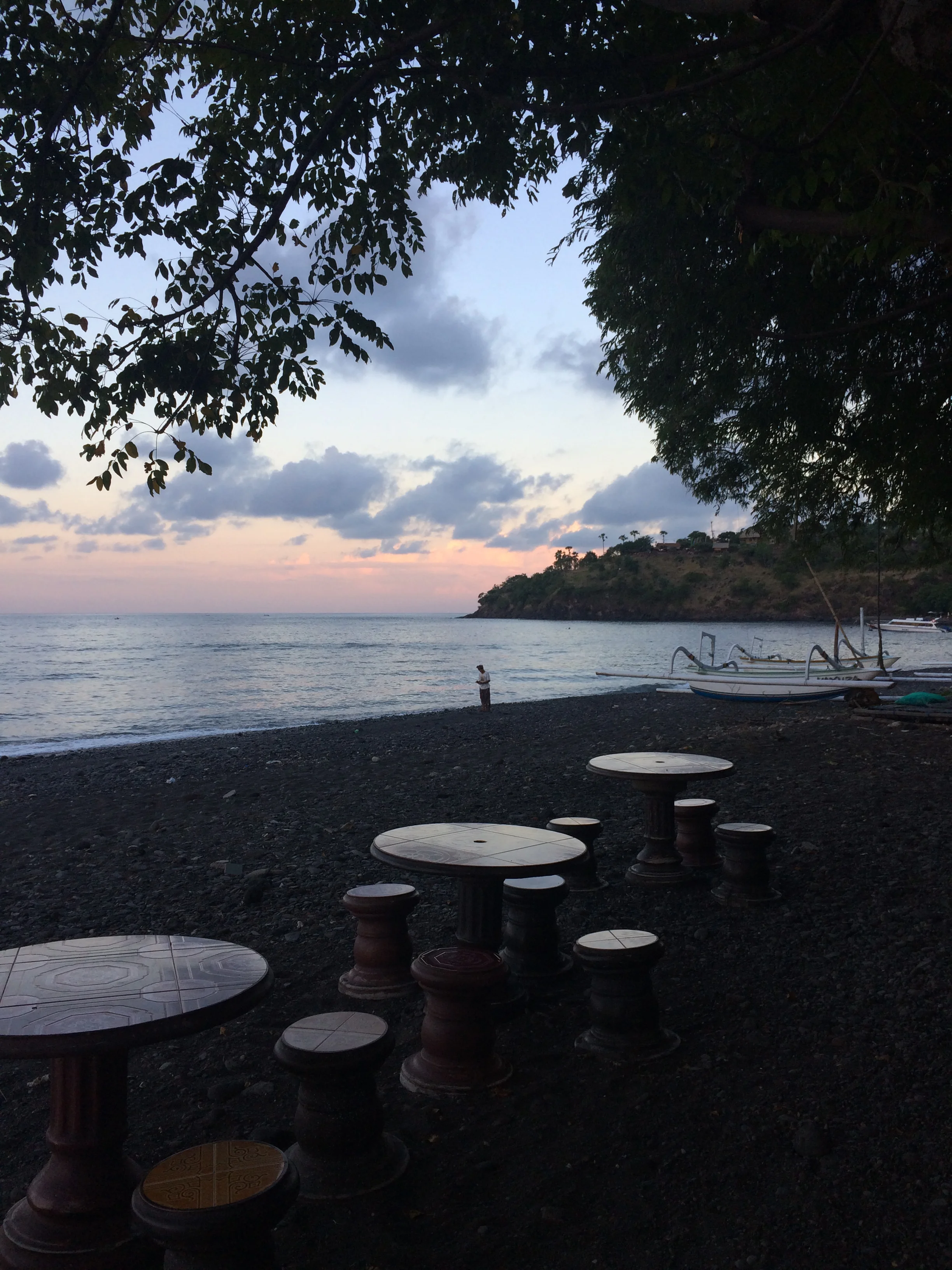Sunset on Amed's black rock beaches. 