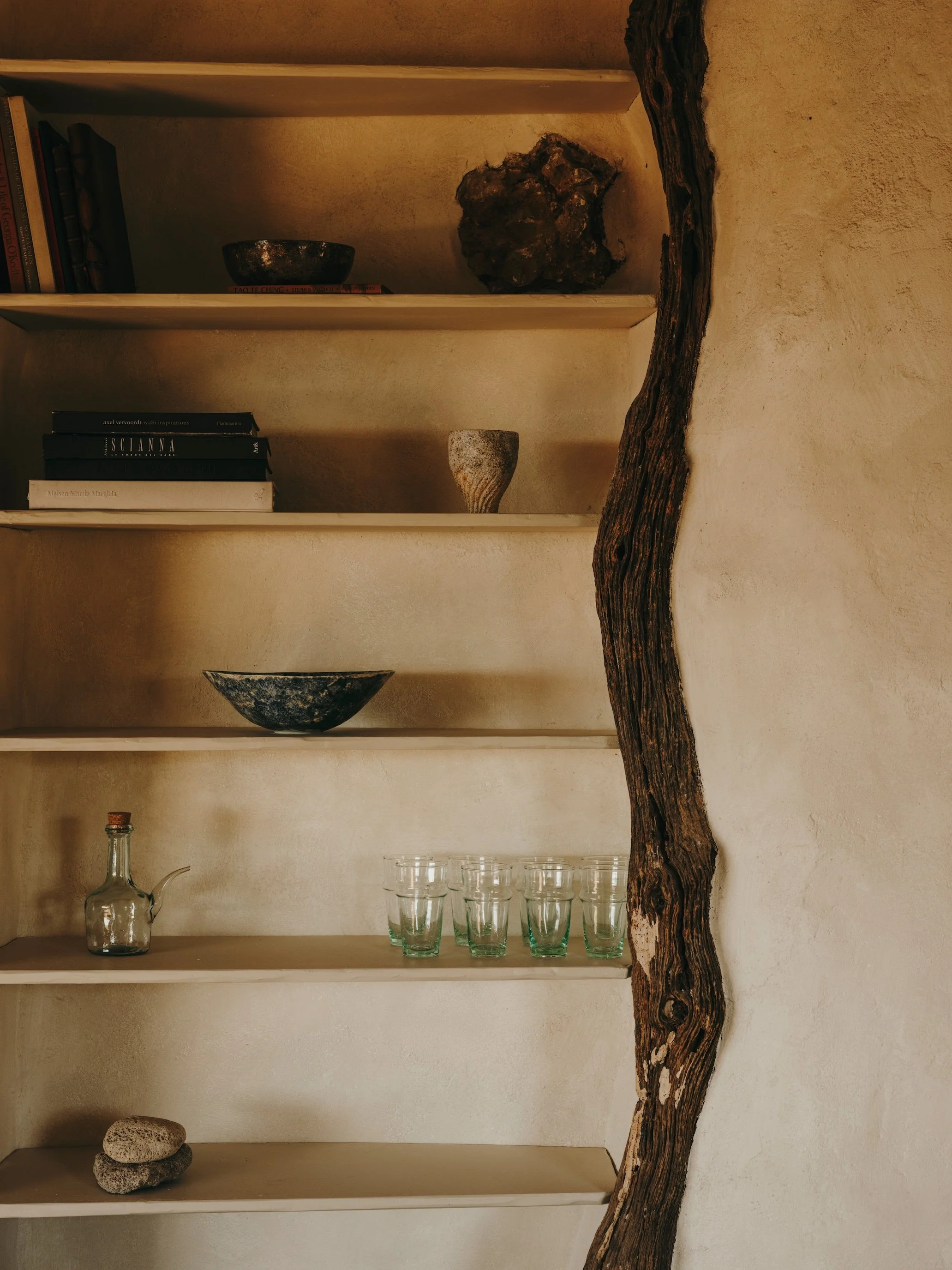 terra coll home stone hut branch shelves.jpg