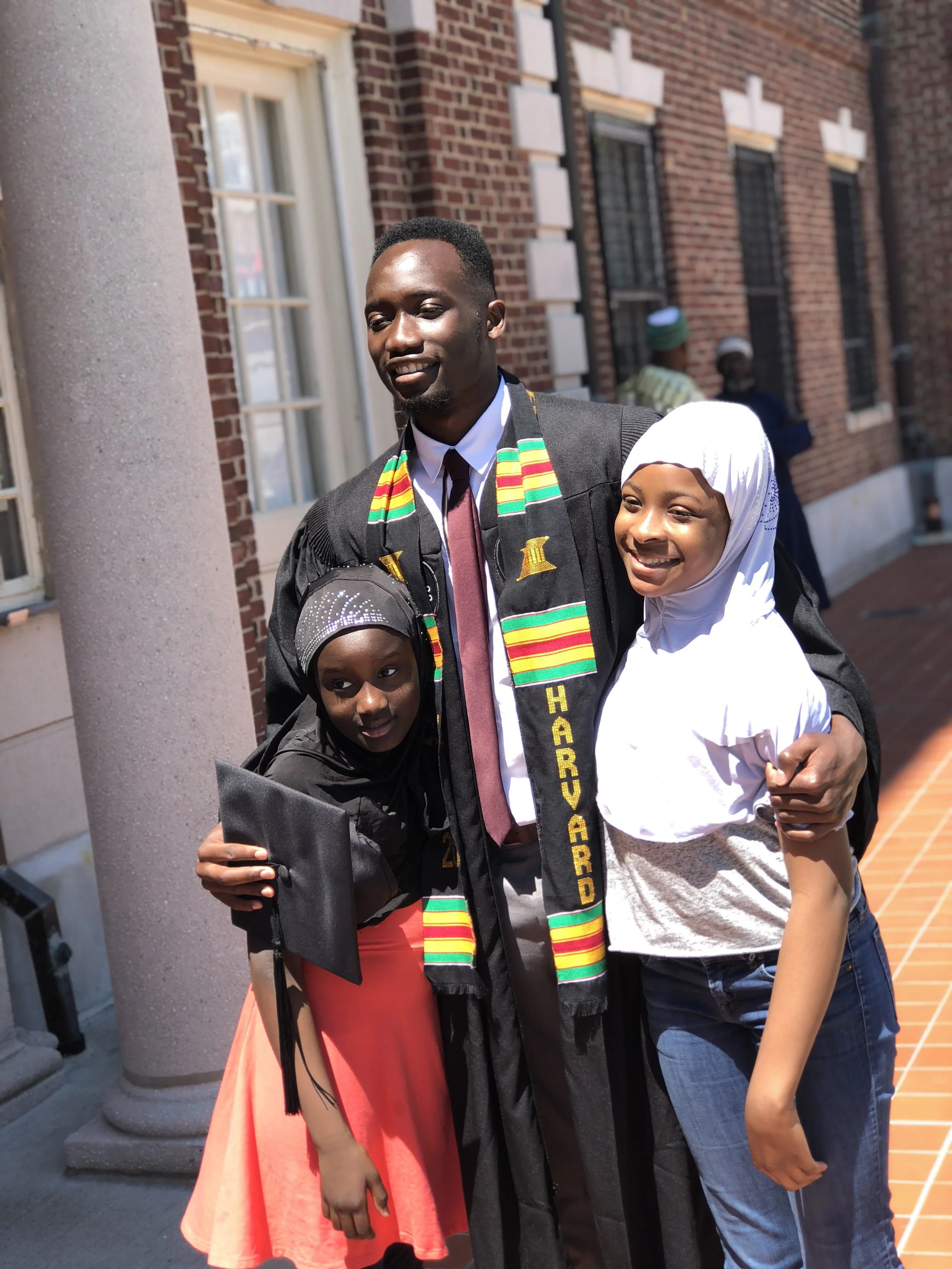 Nuha with his younger sisters at Harvard’s commencement.