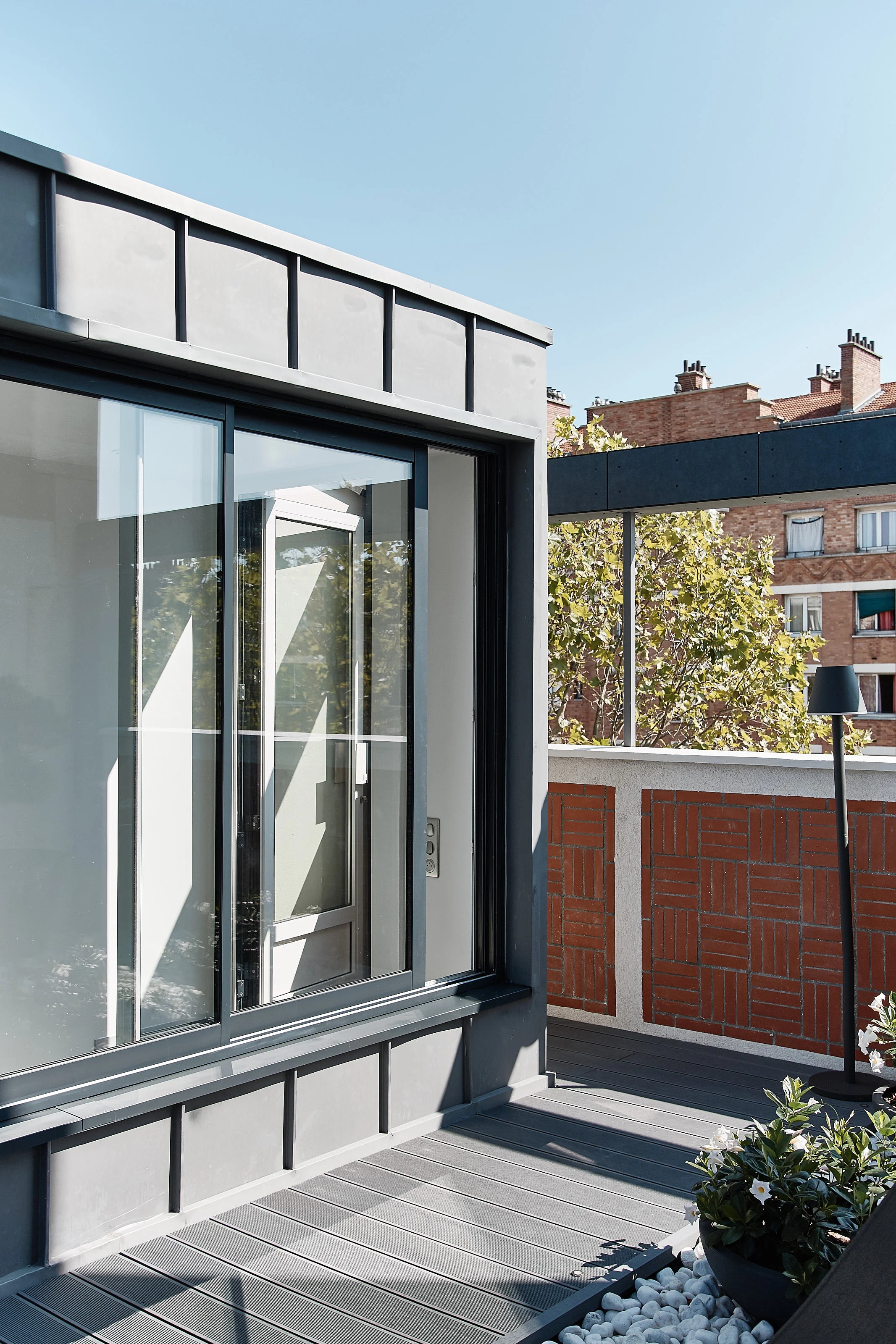 Roof deck access stairway, anthracite zinc cladding, oversized sliding aluminium/glass bay window 