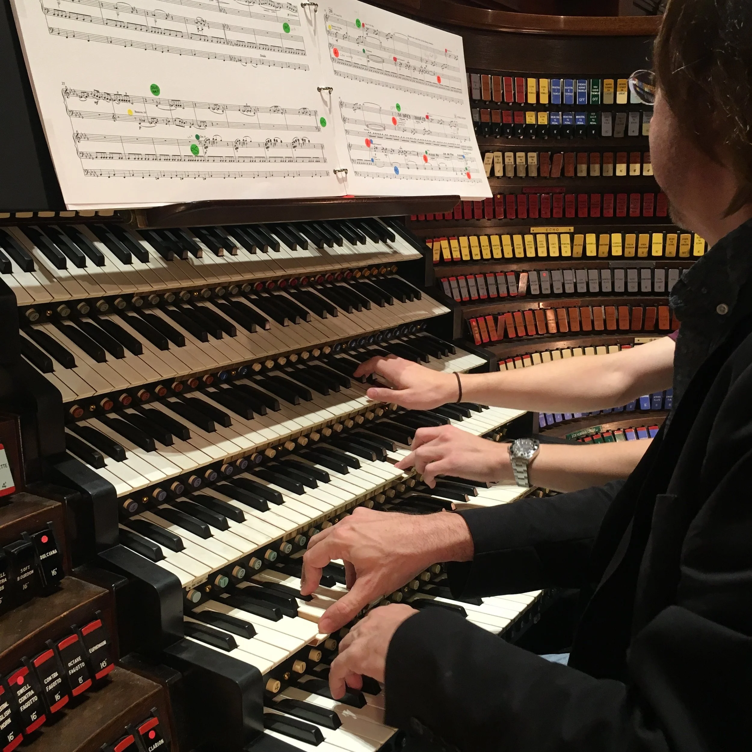 Another view of 2 organists playing.