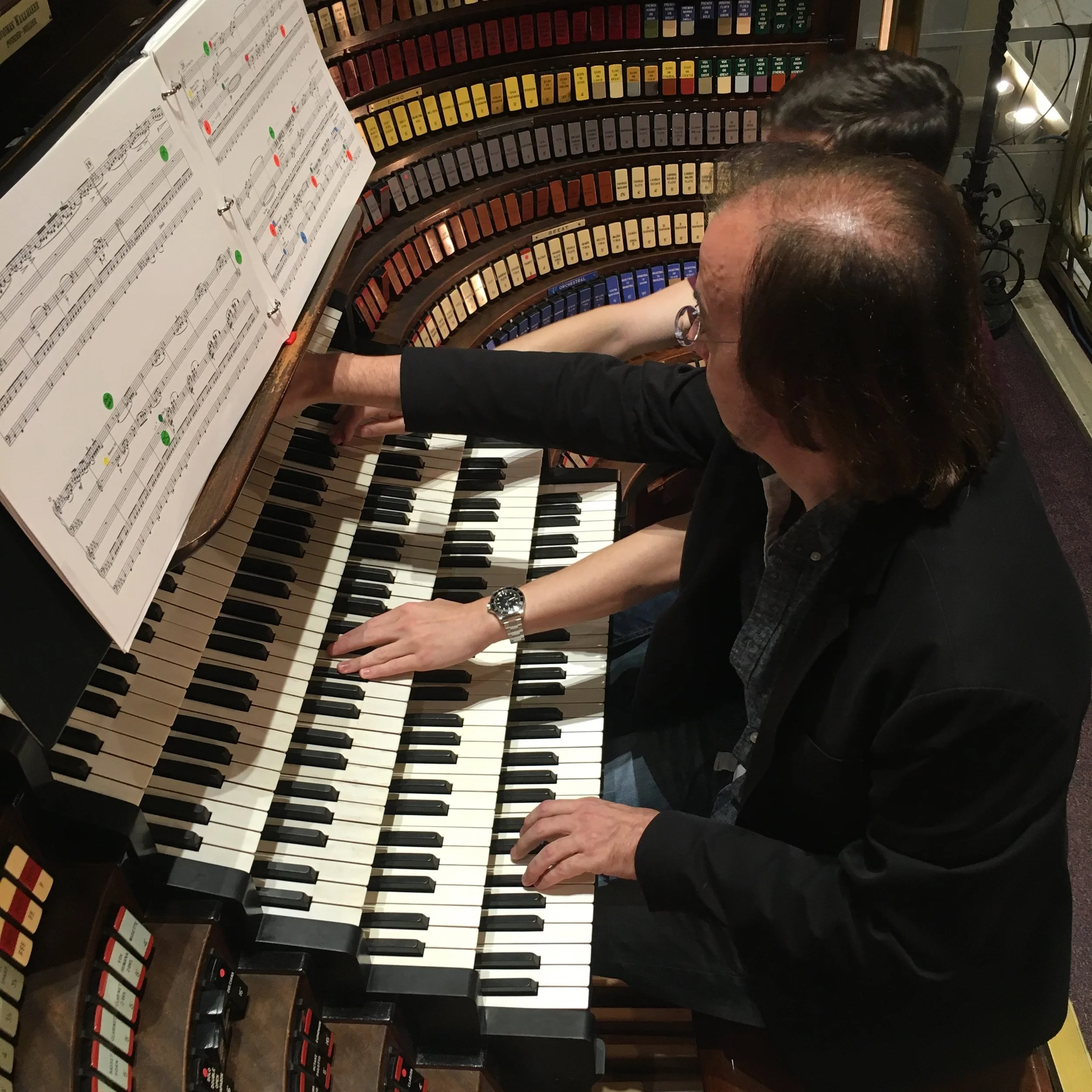 2 organists playing Wanamaker Organ, probably room for a third