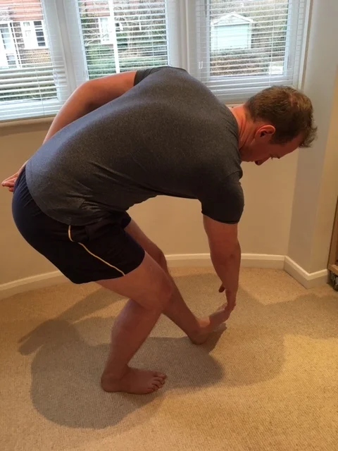 He’s grabbed his foot but hasn’t increased the stretch to the hamstrings