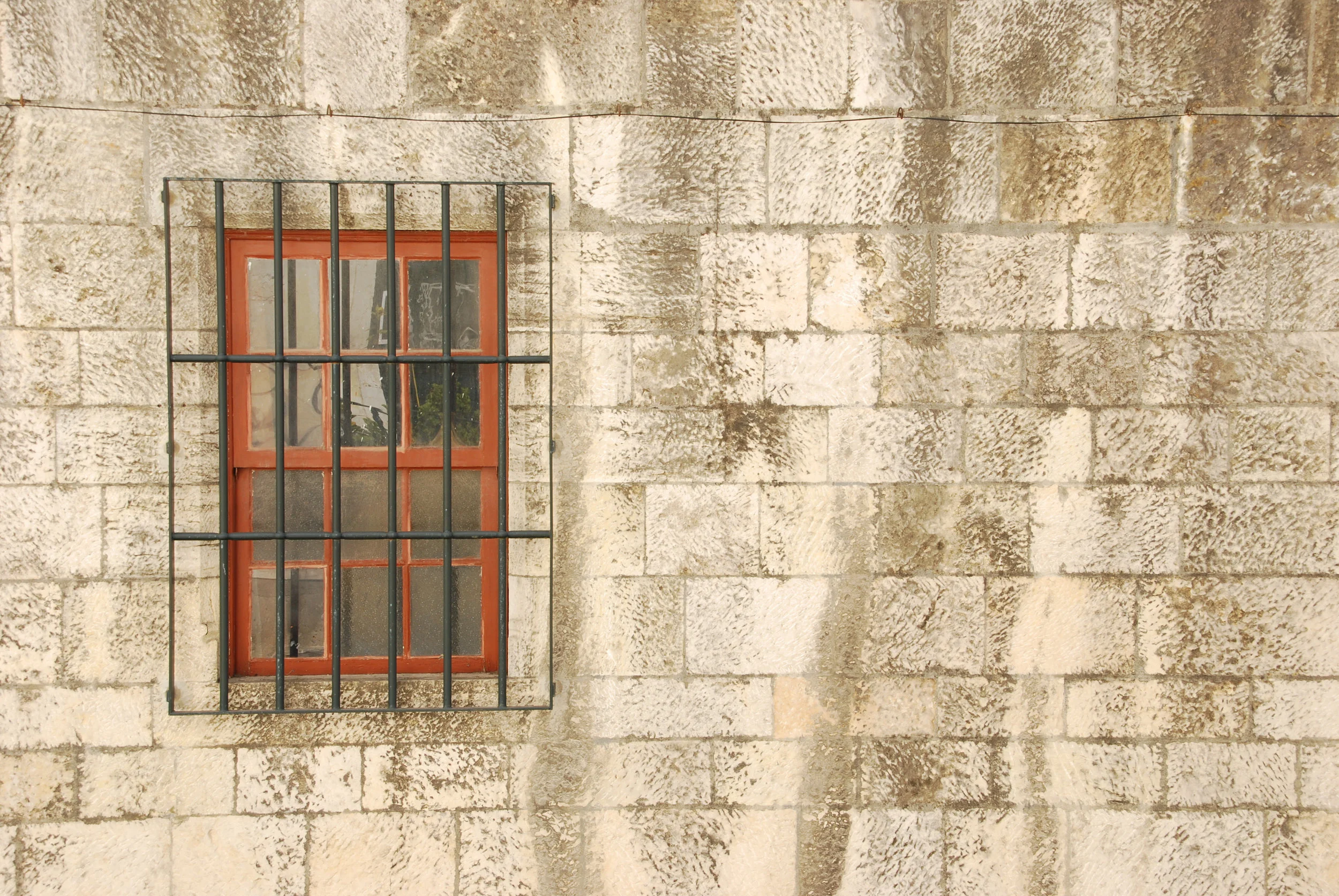 window-with-bars-of-a-medieval-building_7ysNQV.jpg