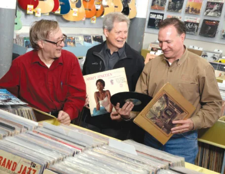 Left to right: Record Town owners Gerard Paul Daily, Tom Reynolds and Bill Mecke discuss some favorite LPs.