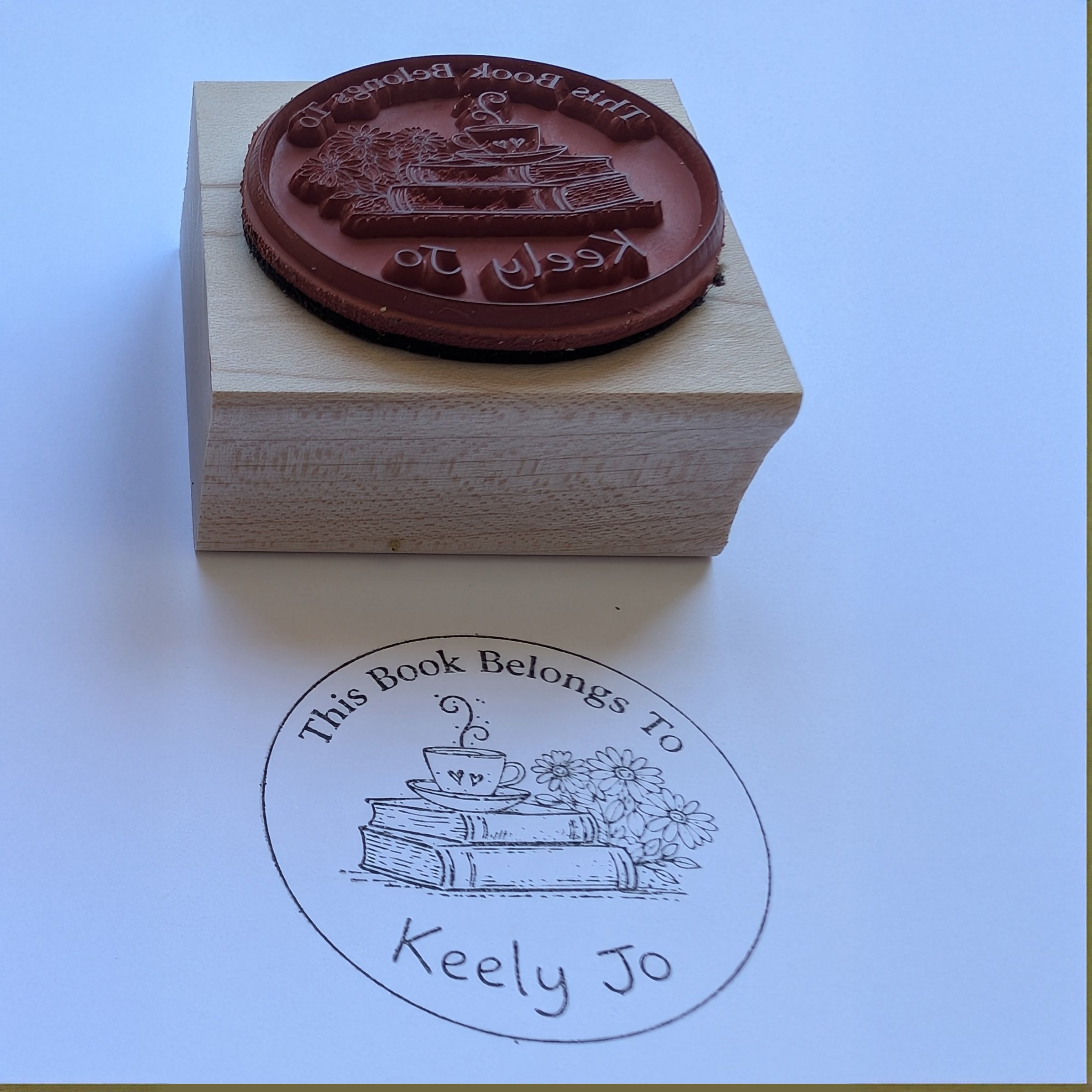 Close-up of deep-etched vulcanized rubber stamp showing crisp detail — individual flower petals, fine lines, and clean recessed background
