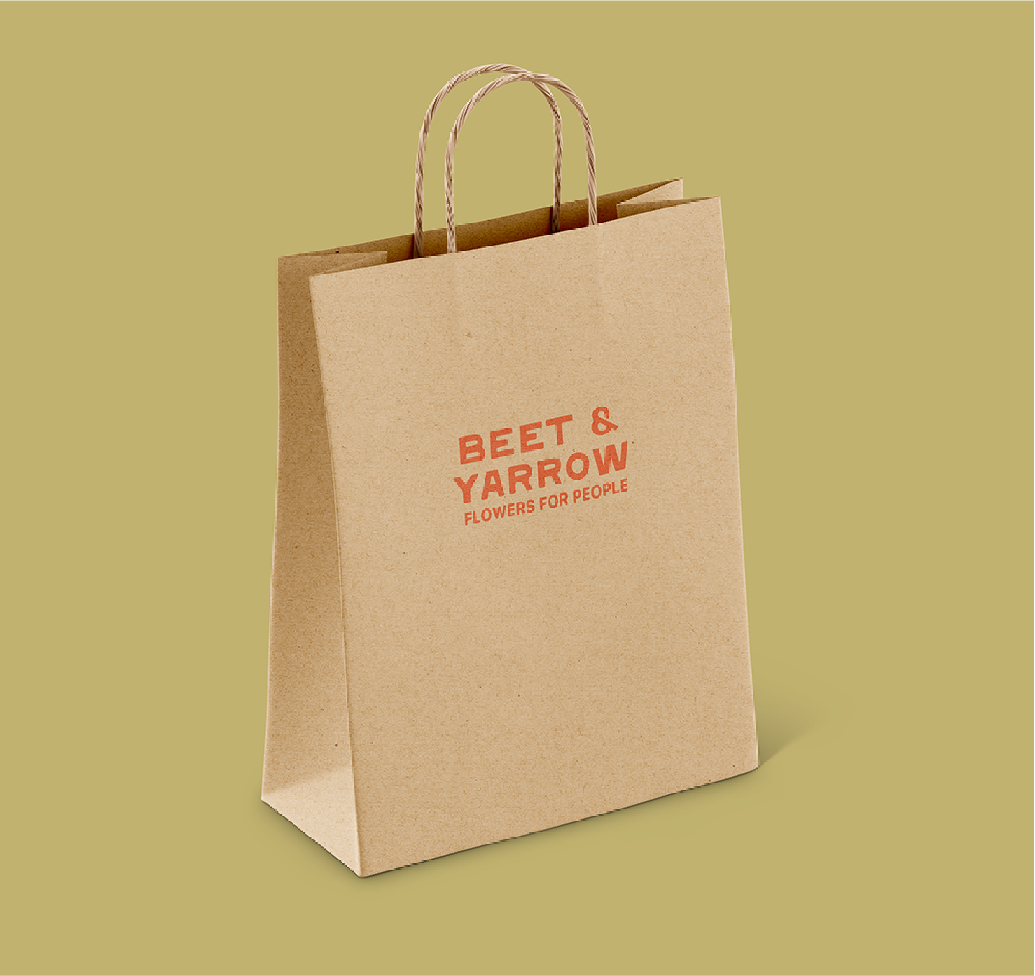 Kraft bag stamped with Beet & Yarrow flowers for people in red ink with a soft sage green background