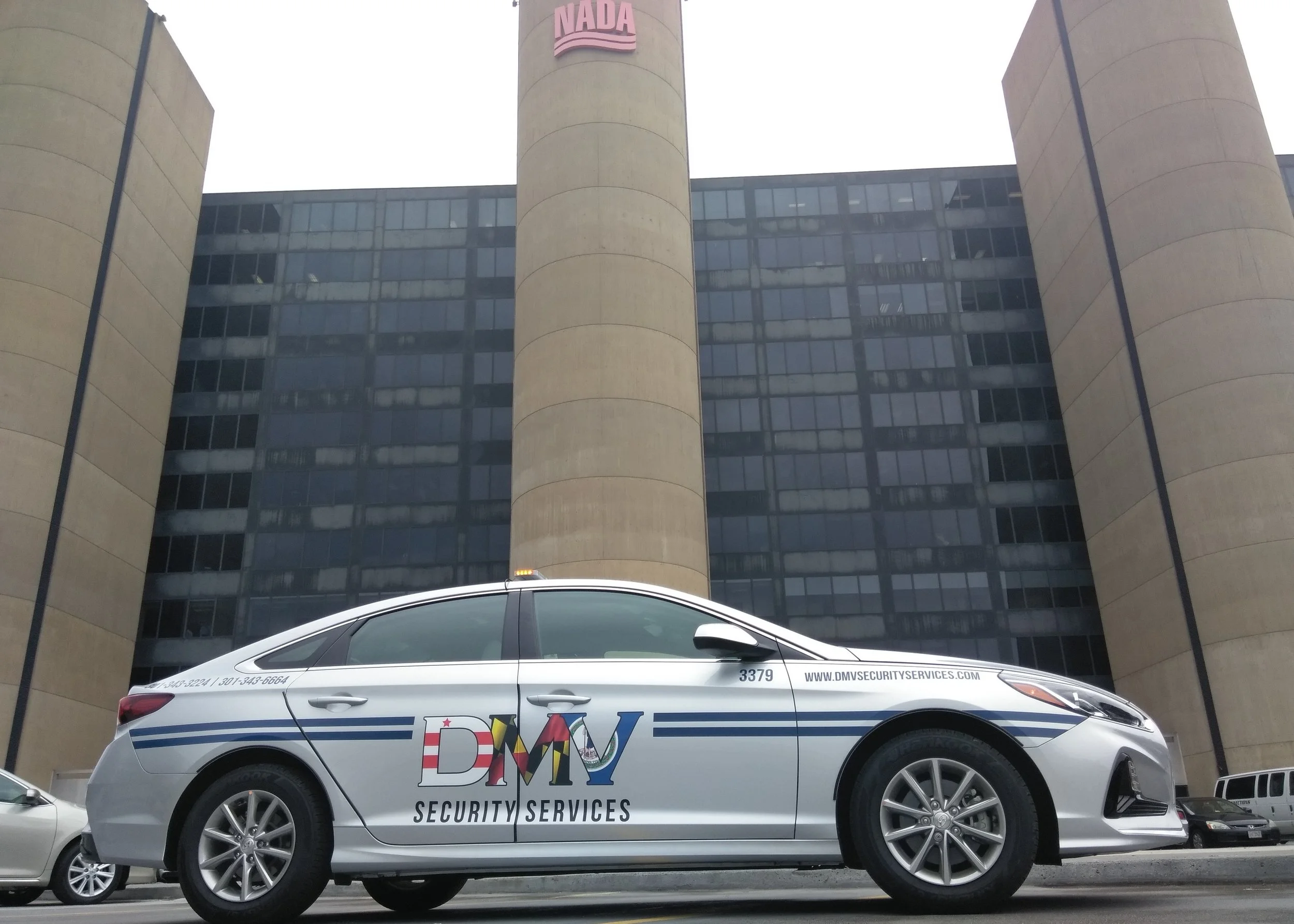 DMV Cruiser on client's property, with lights activated.