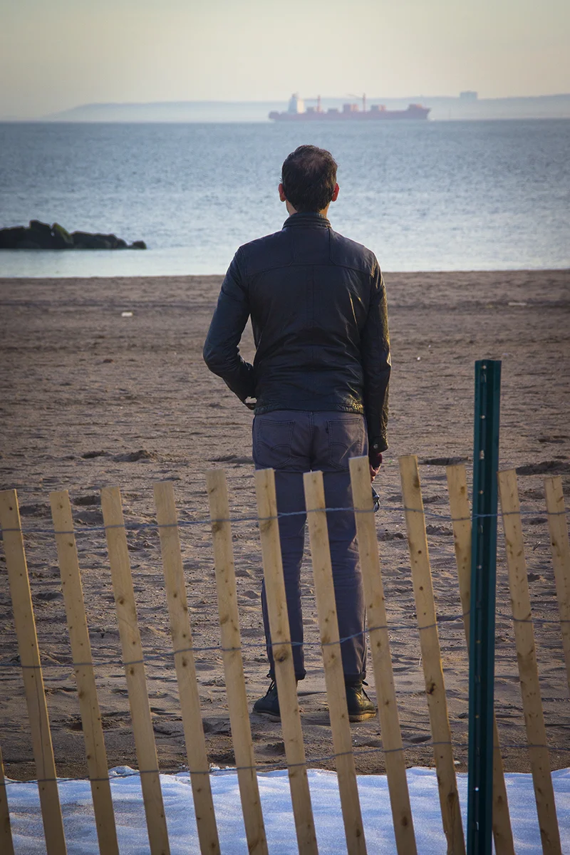 Young man from back viewing ship on horizon_79.jpg