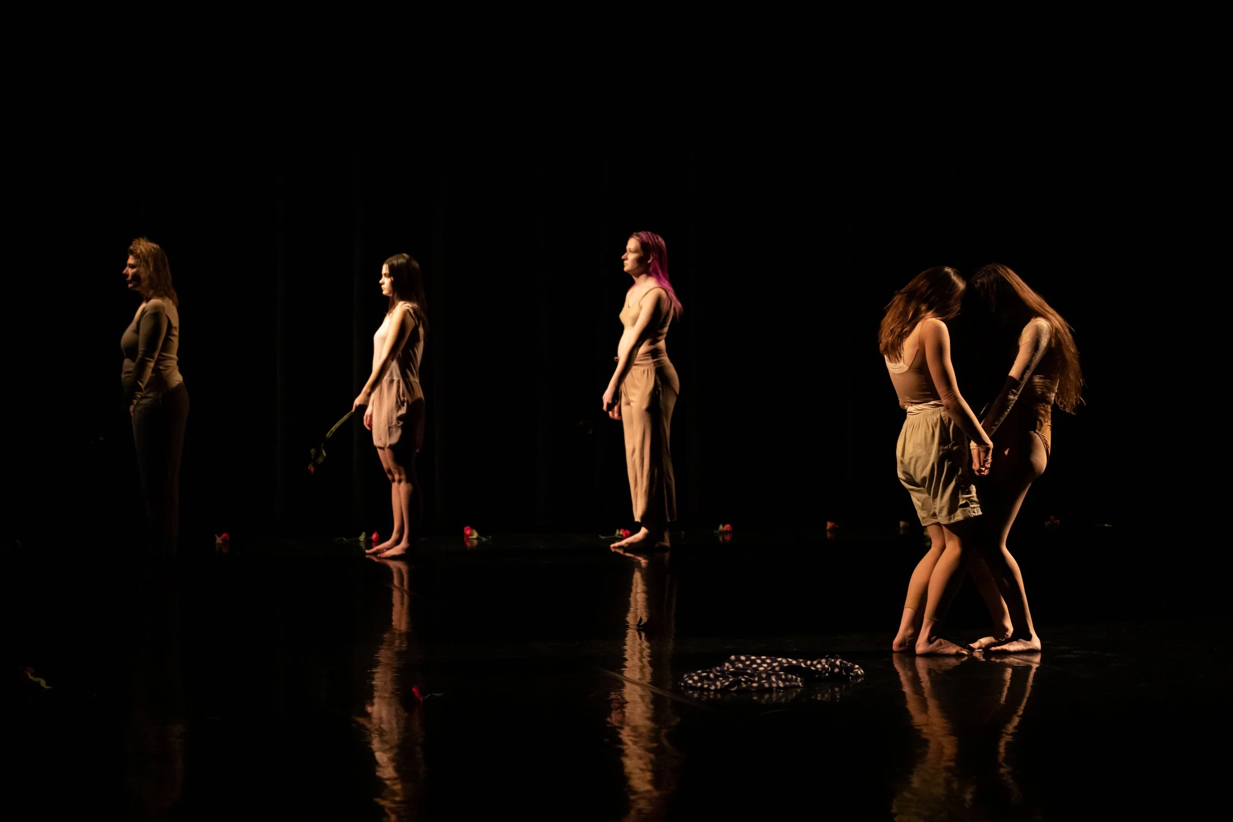 morgaine and anna mid action as a line of bystanders look over with roses swinging from their limbs.