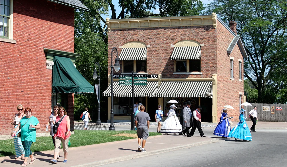 Costumed historical reenactors walk down Main Street.