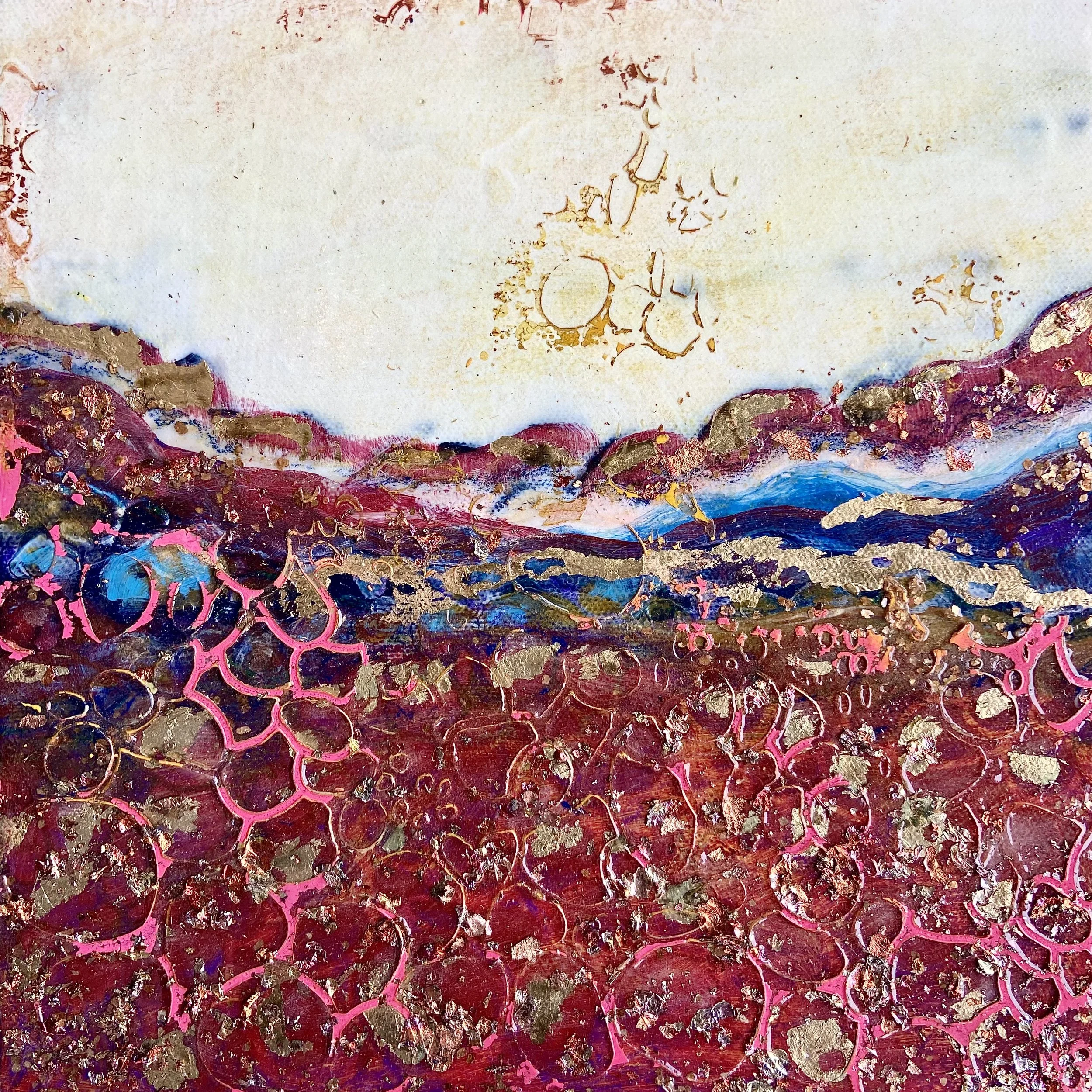 Abstract painting with textured maroon and pink circles in the foreground, layered blue, purple and brown mountains in the middle, and a pale cream sky with gold accents and subtle markings at the top.