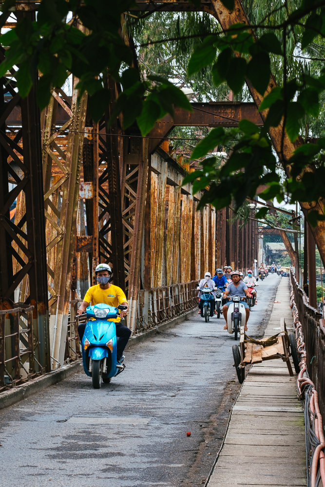 Scooters in Hanoi old quarters old railway bridge