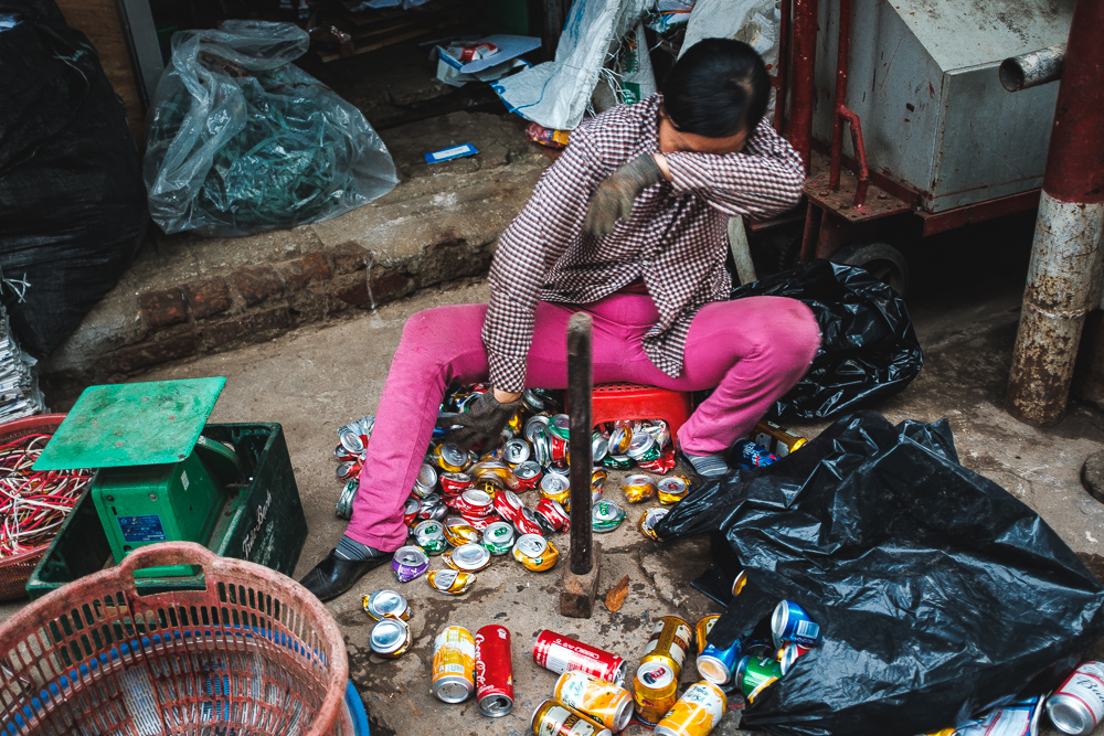 Hanoi woman sorting out the empty cans for recycling.