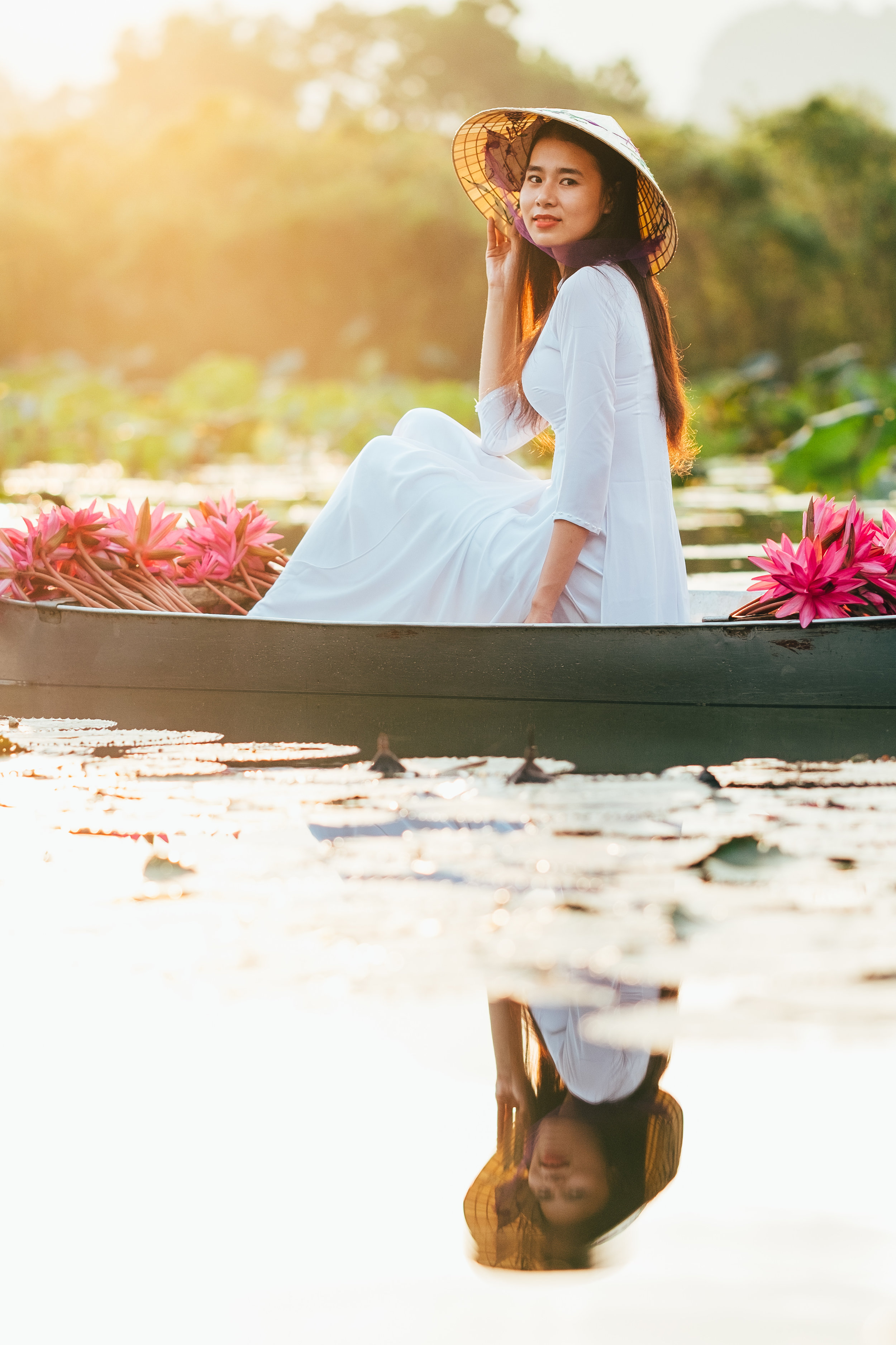 A beautiful sunrise and a vietnamese girl in her tradional white