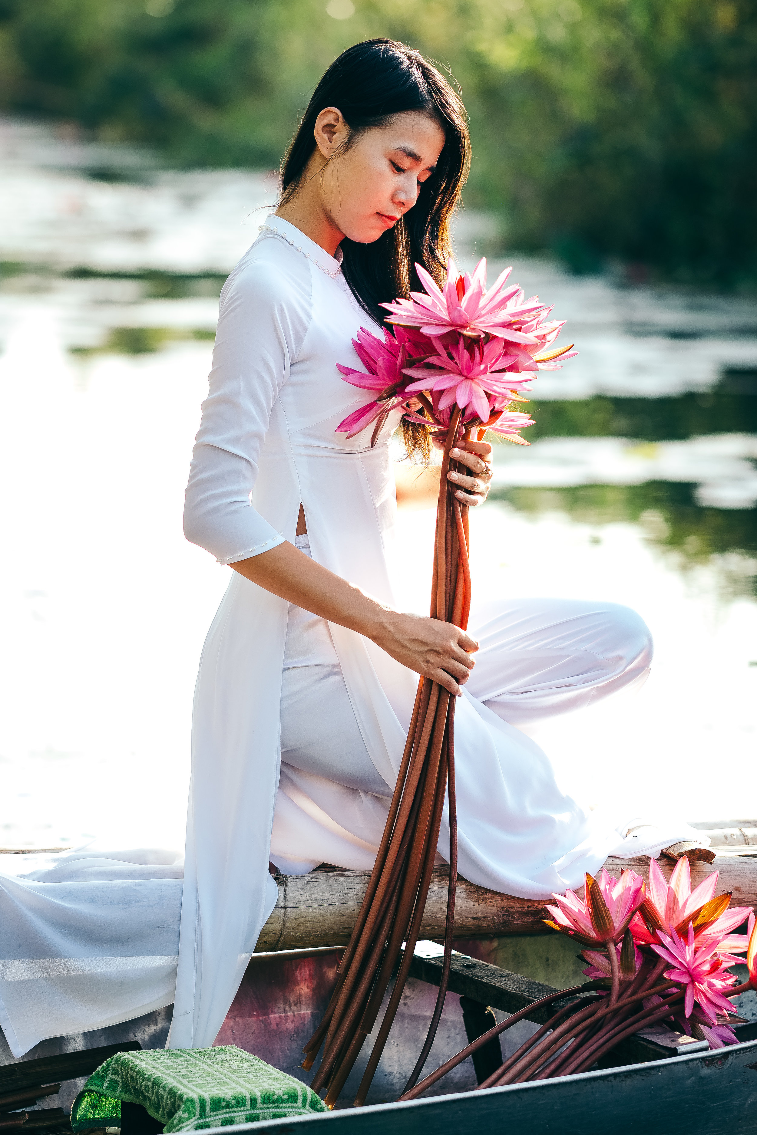 Vietnamese girl with red lotus in hands