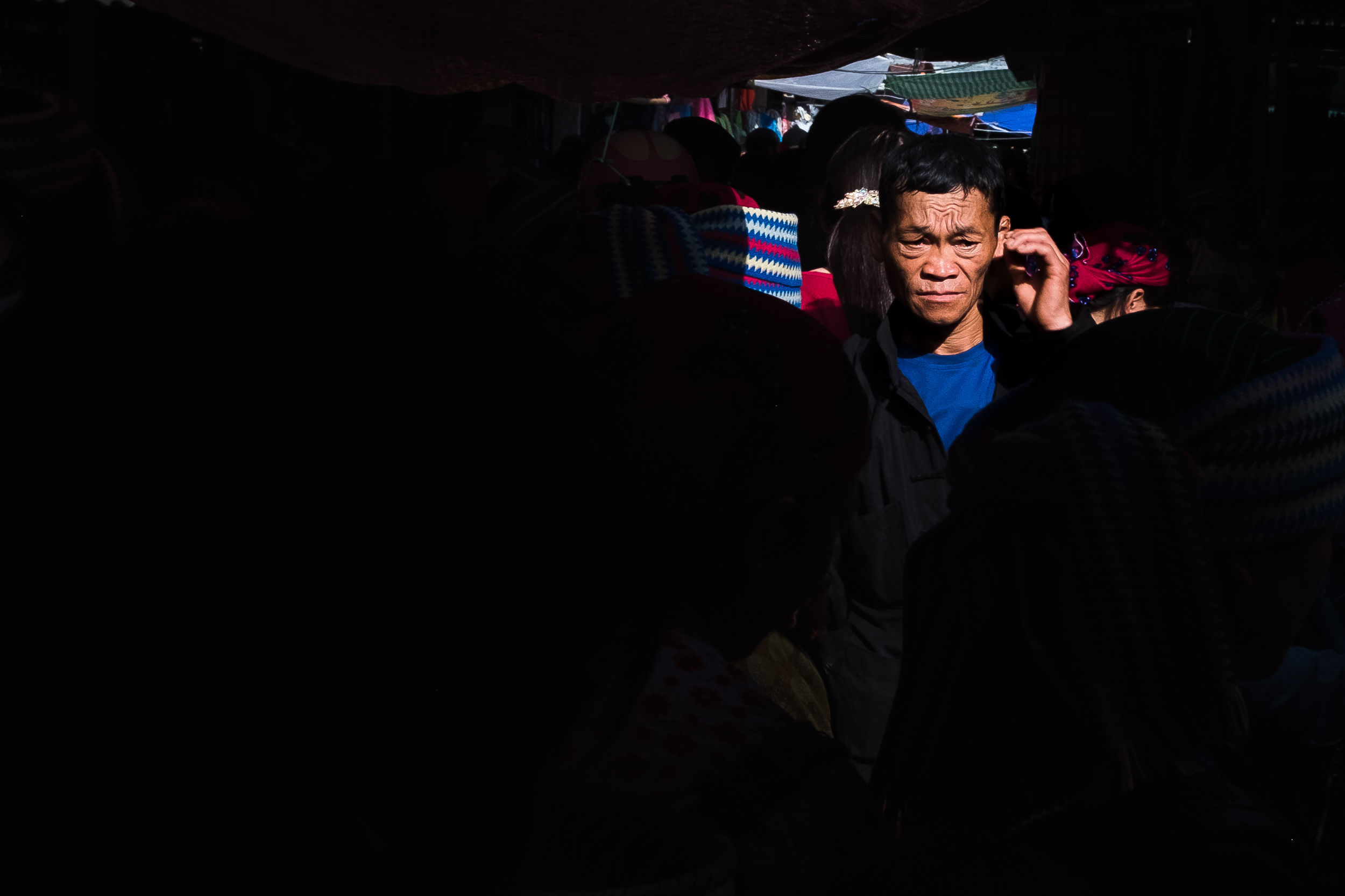  Man walking in a alleyway of Dong van market 