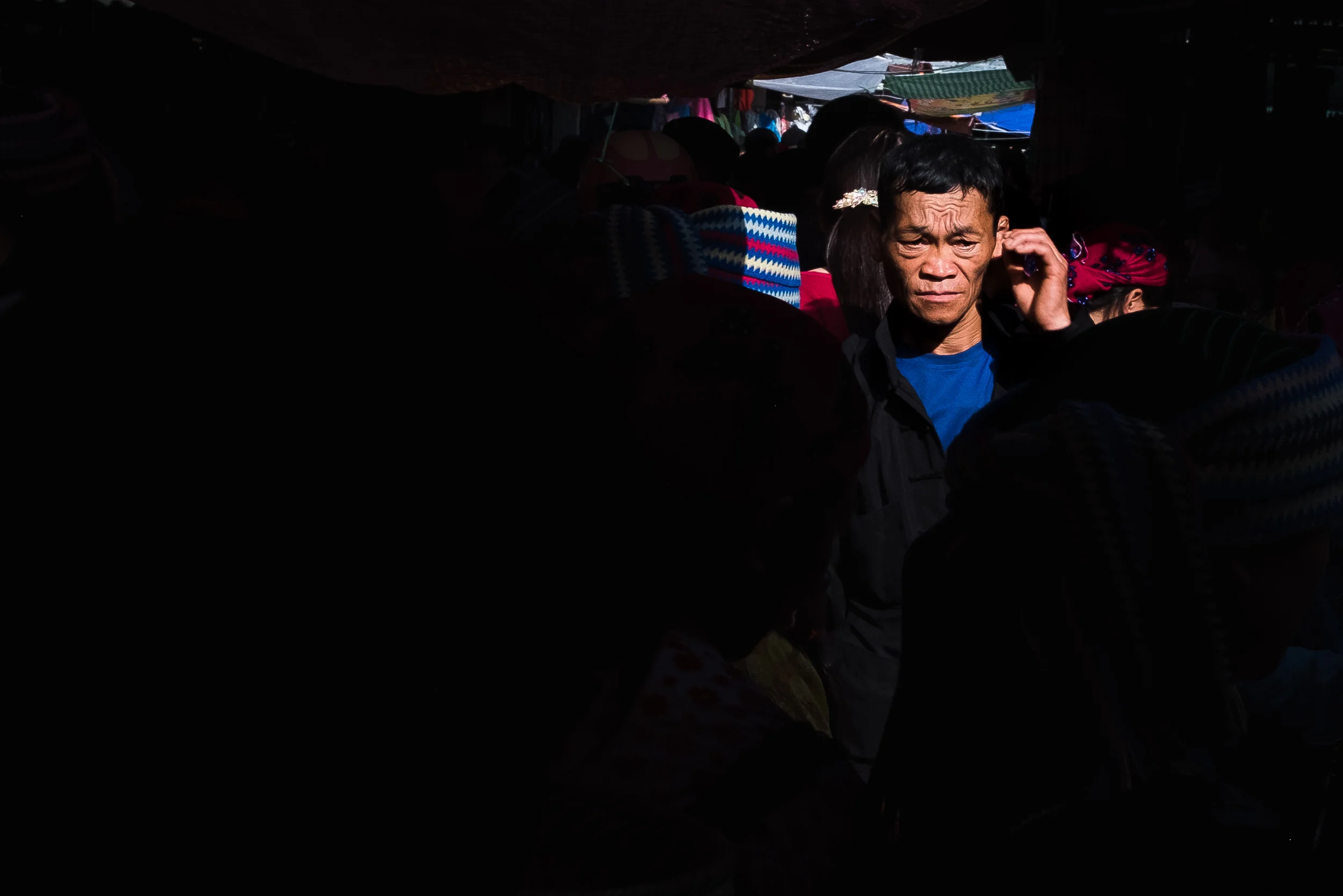Man walking in a alleyway of Dong van market