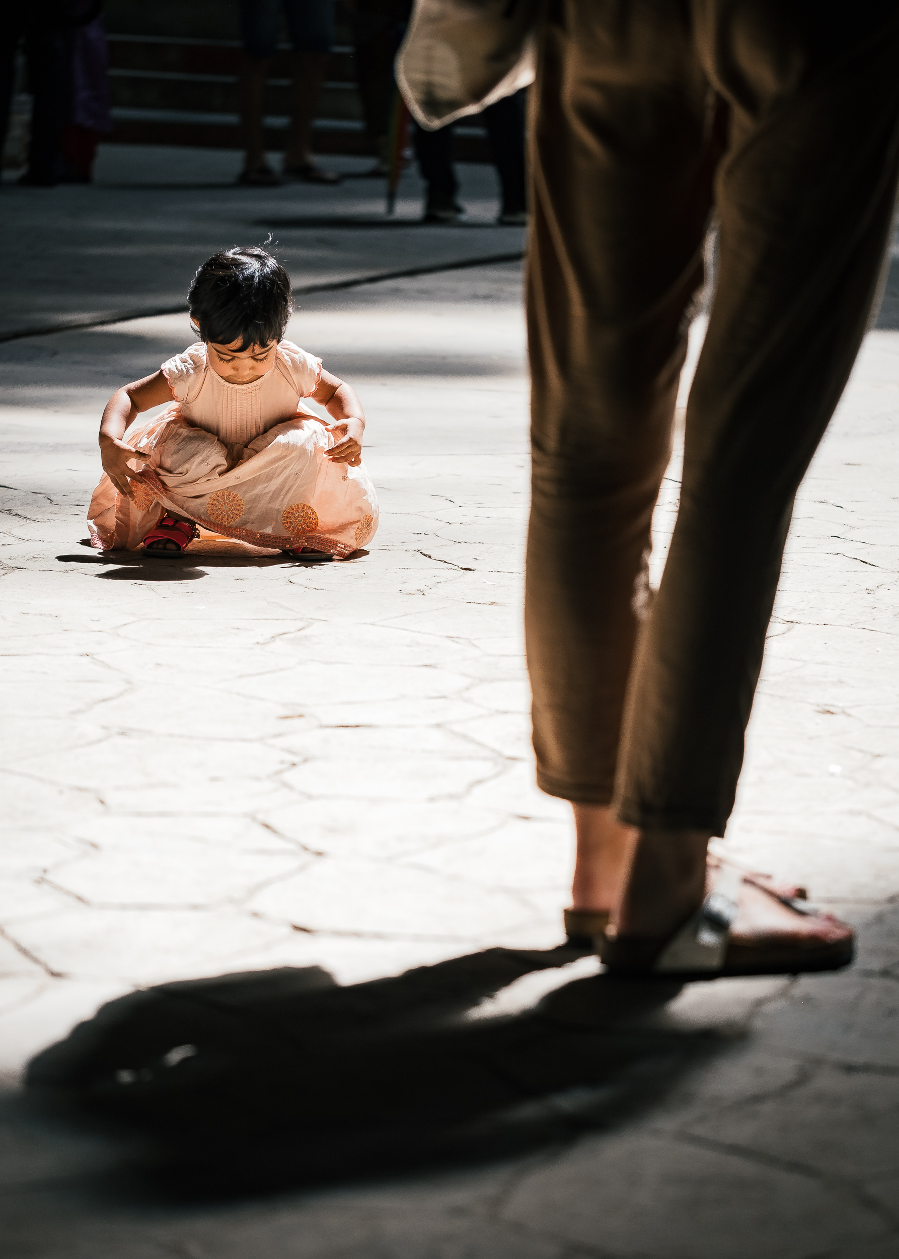  Child sitting on the floor under the sunlight in Batu Caves- Malaysia  Fujifilm X-T2 + Fujinon XF 80mm f/2.8 R LM WR OIS Macro  1/400sec, f/2.8, ISO 200 