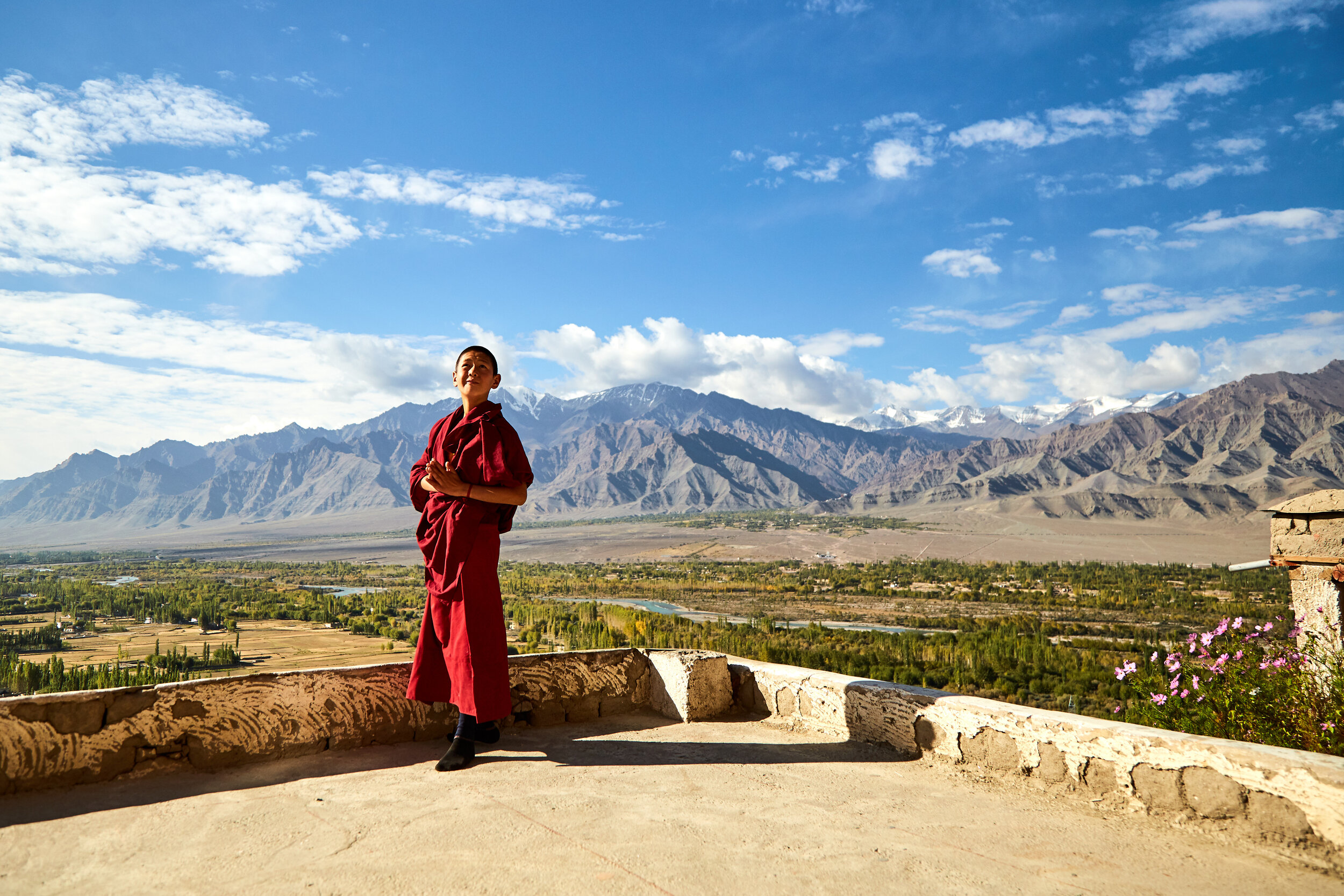  A novice monk doing morning prayers looking at the sun. They follow the traditions of Mahayana buddhism. 