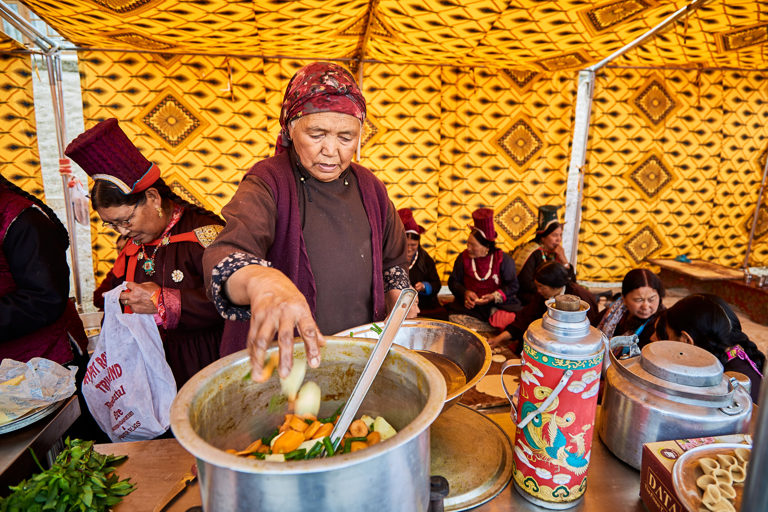  With the tourism booming the local council has organised several events around the year. Group of women making traditional food at such an event. 