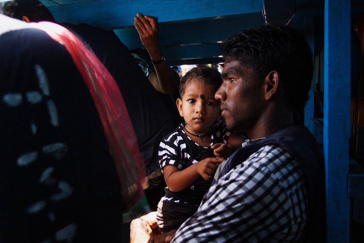  A father and his child inside a passenger boat which runs between the pungudutivu and Nainativu ports in Jaffna-Sri Lanka.Daily hundreds of people travel between these islands to reach the famous Nagapooshani Amman Temple, and Naagavihara in Nainati