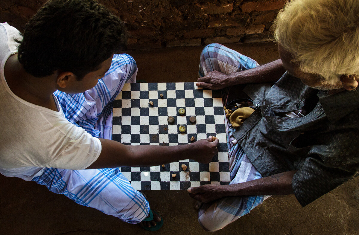 Playing board game in Asian villages