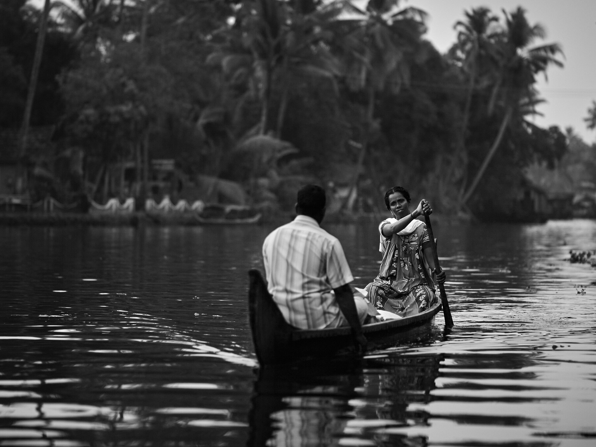  A family was navigating the backwaters in a small wooden boat in Alappuzha, Kerala. 