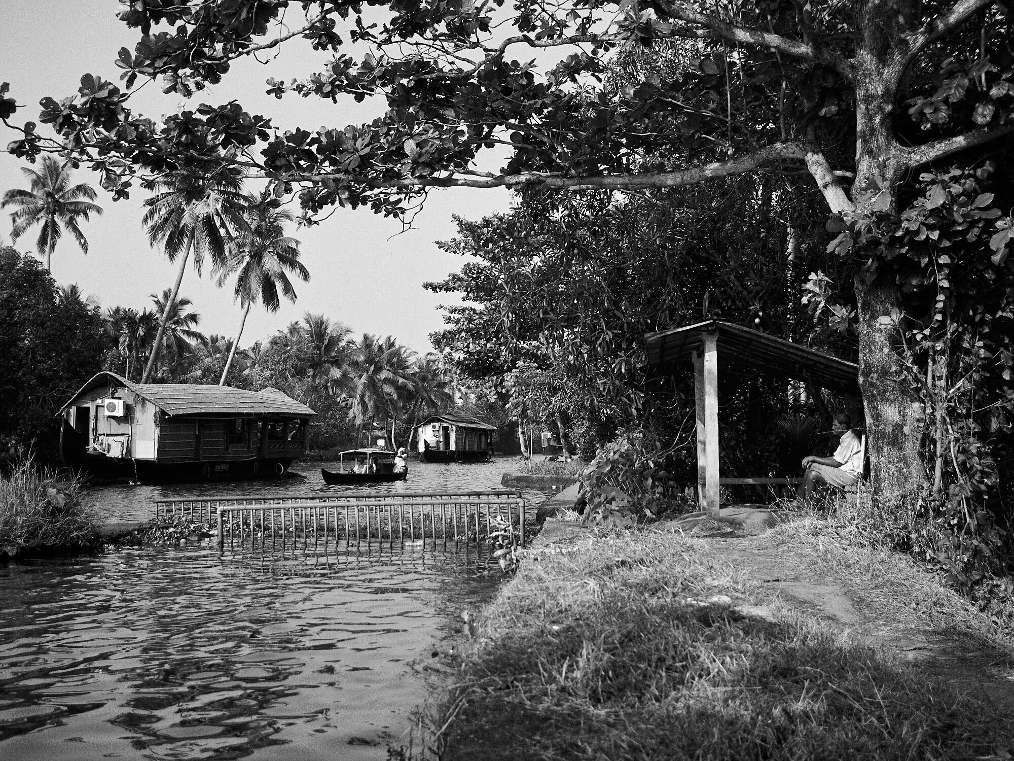  A man quietly sitting at a resting place near a backwater channel in Alappuzha, Kerala. 