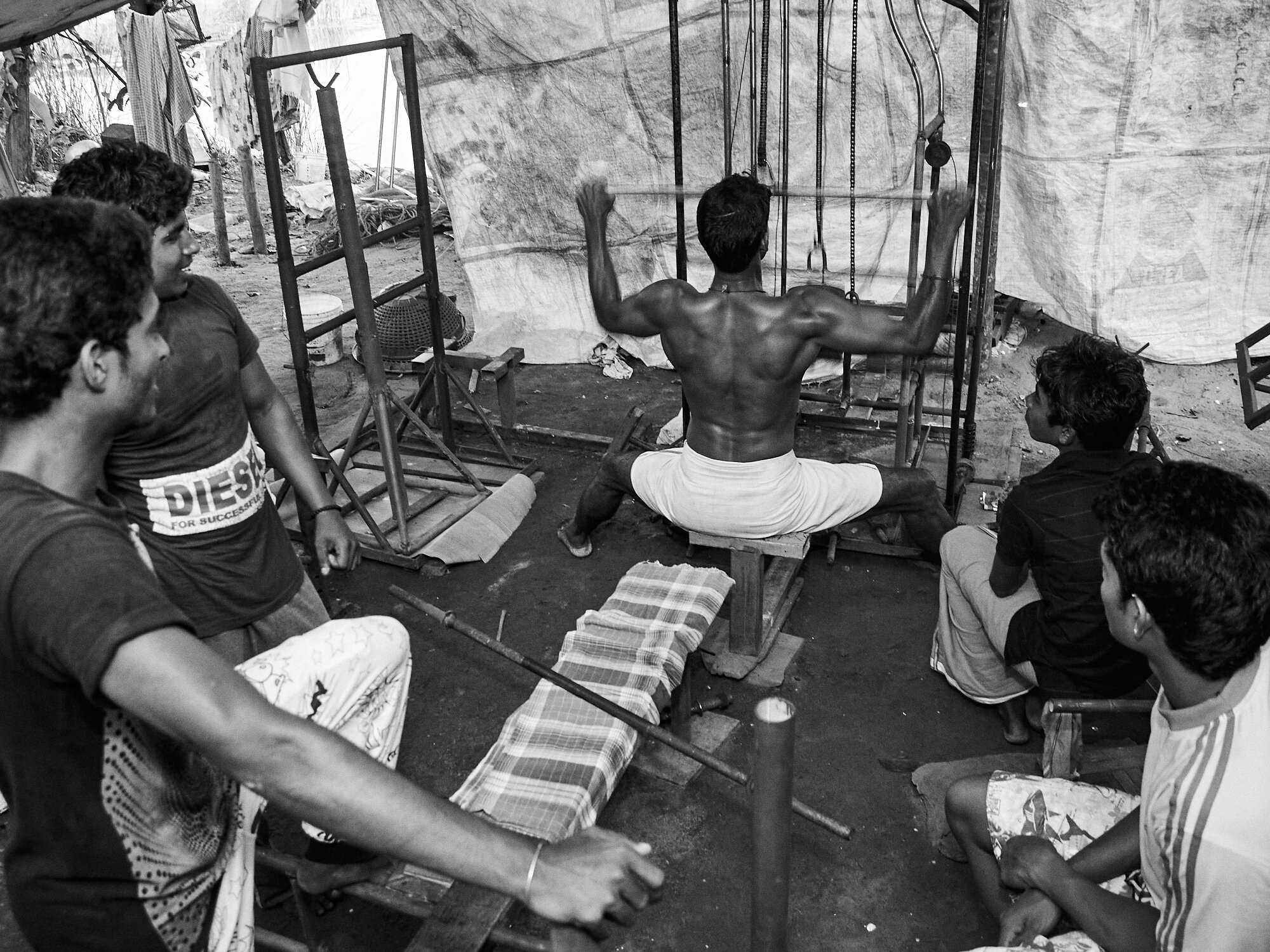  Group of young men enjoying an exercise session at their backyard gym setup in Alappuzha, Kerala. 