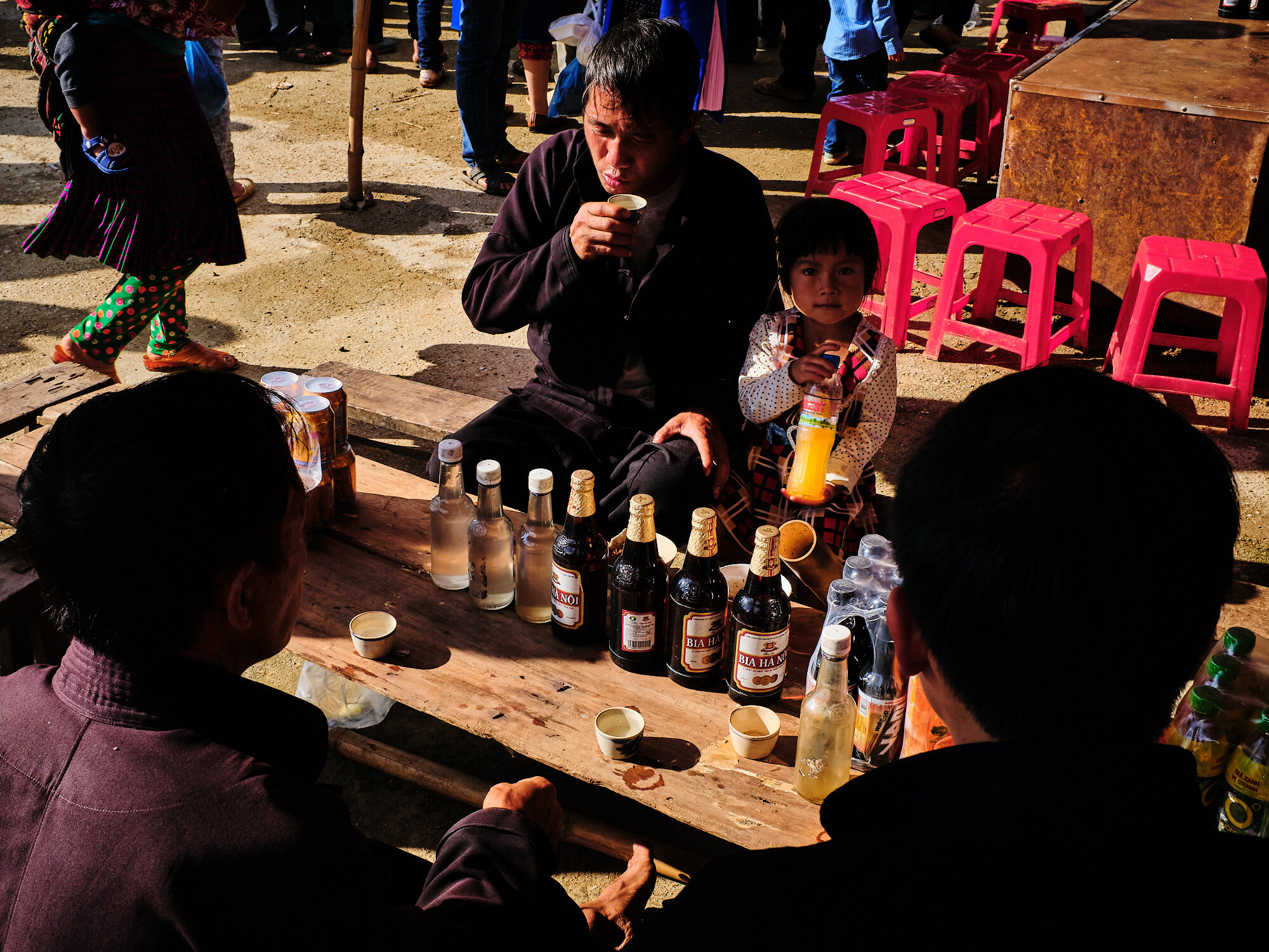  A group of men enjoying rice wine at Dong van market 