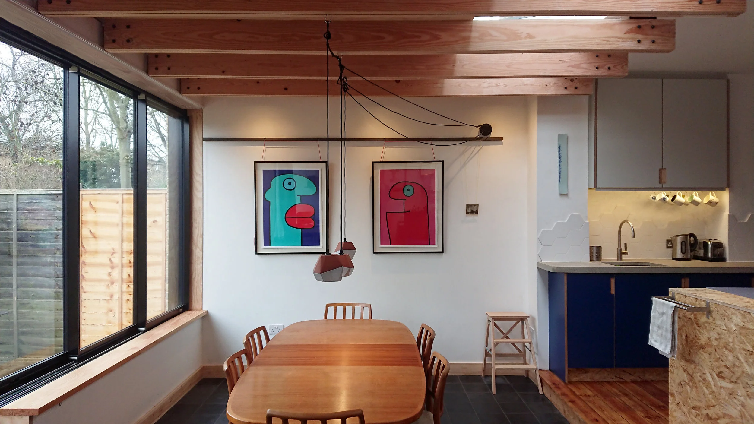 Douglas Fir beams hang from hidden steel beam above