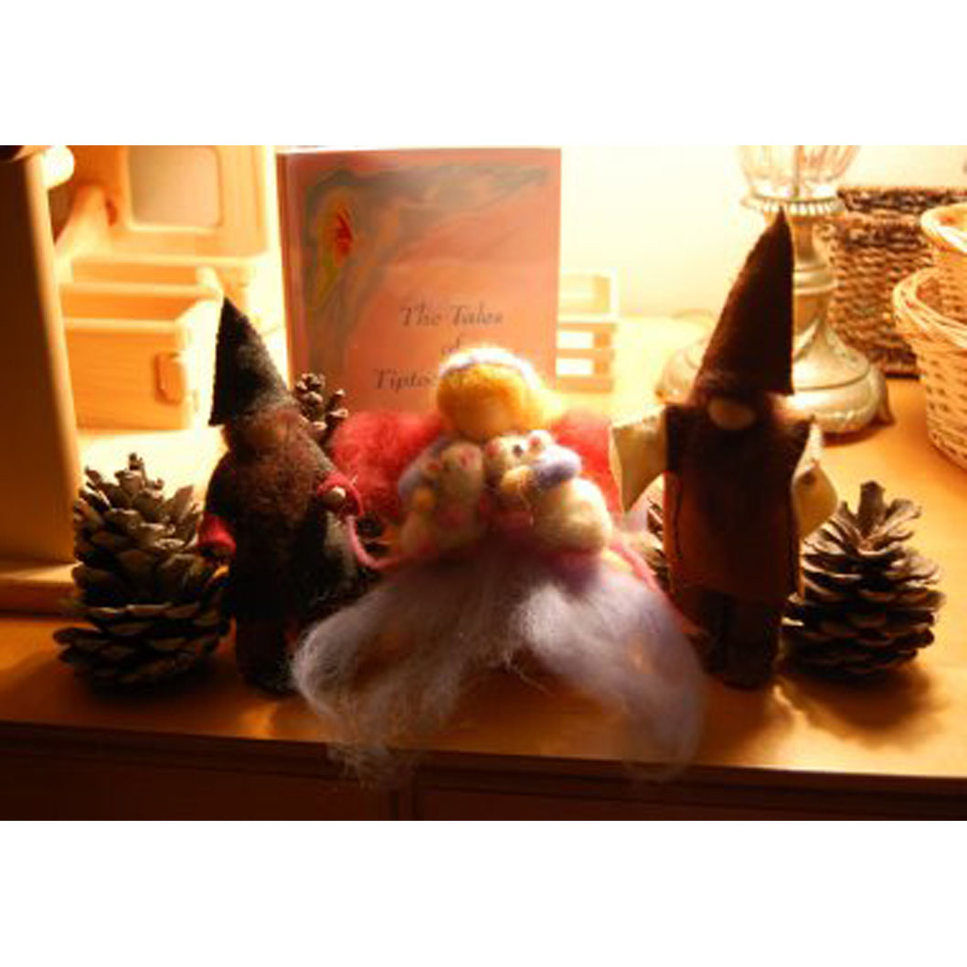 Tiptoes Lightly and the gnomes beside a book of her tales.