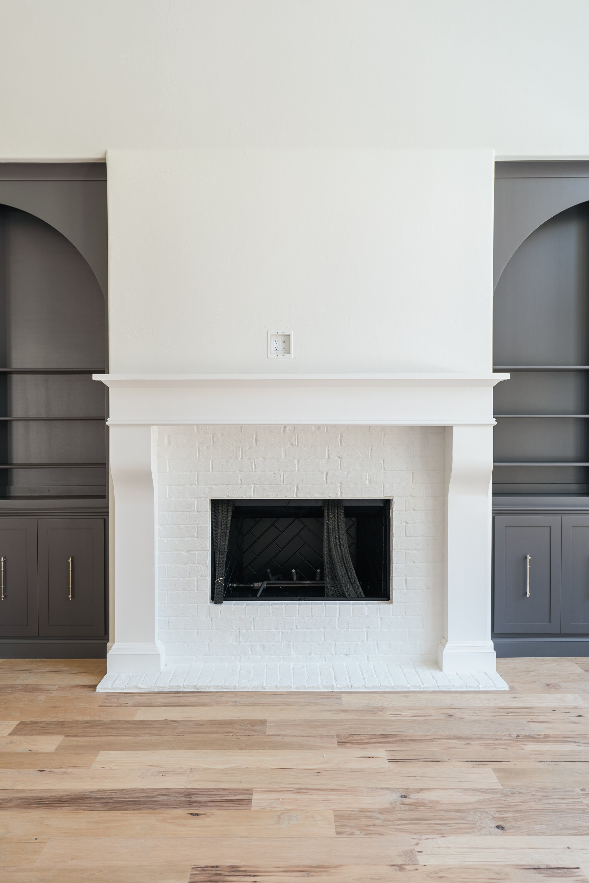 White fireplace with black arches